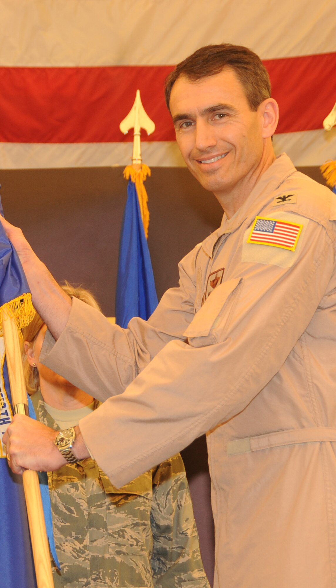 Col. Mike Minahan, newest 380th AEW commander, holds the 380th Air Expeditionary Wing flag after he took command of the 380th AEW during a change of command ceremony at a non-disclosed base in Southwest Asia on June 14, 2010. (U.S. Air Force Photo/Senior Airman Jenifer H. Calhoun/Released)