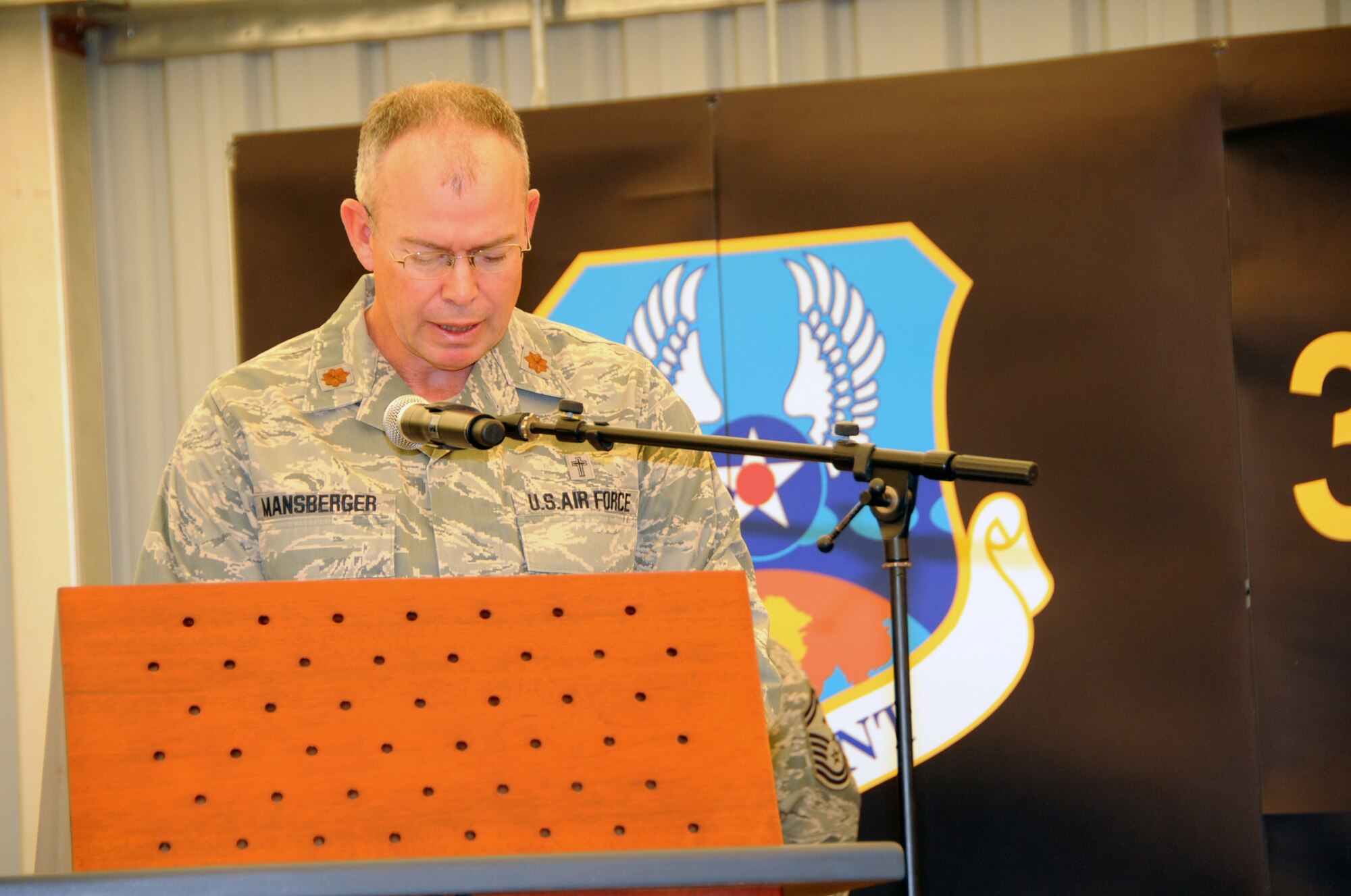 Chaplain (Maj.) David Mansberger, 380th Air Expeditionary Wing lead chaplain, reads the invocation during the 380th AEW change of command ceremony June 14, 2010, at a non-disclosed base in Southwest Asia. During the ceremony, Col. Mike Minahan took command of the wing from Brig. Gen. Bryan Benson. The 380th AEW supports operations Iraqi Freedom, Enduring Freedom and the Combined Joint Task Force-Horn of Africa. (U.S. Air Force Photo/Senior Airman Jenifer H. Calhoun/Released)