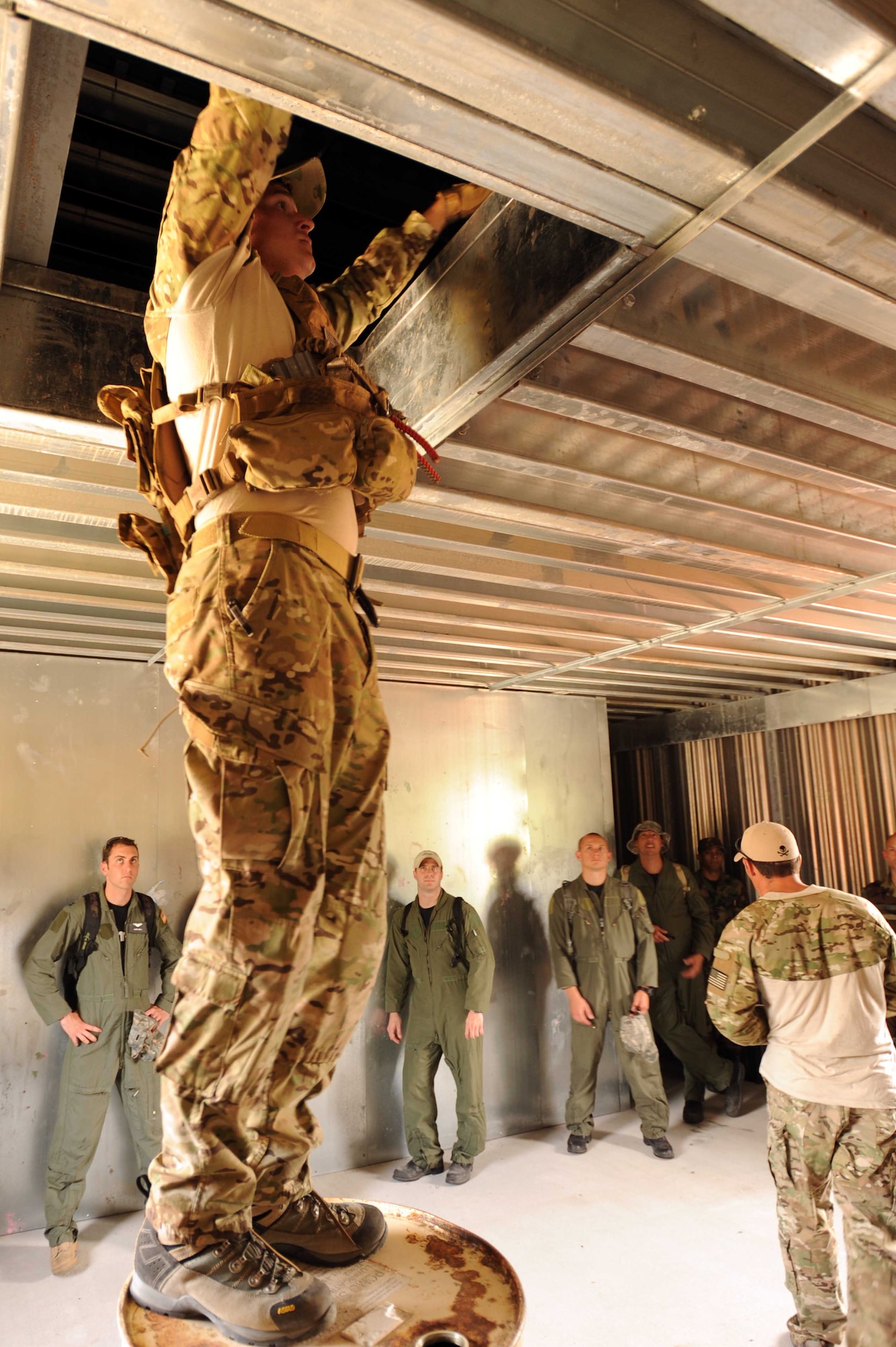 A Survival, Evasion, Resistance and Escape specialist demonstrates to Airmen how to maneuver  through a building during combat skills training at an undisclosed location within the Eglin Range, Fla., May 13, 2010.  SERE specialists are able to utilize the multitude of resources and experiences from their fellow 1st Special Operations Support Squadron Range Support flight to prepare Airmen for situations that may happen in combat. (DoD photo by U.S. Air Force Senior Airman Matthew Loken/Released)