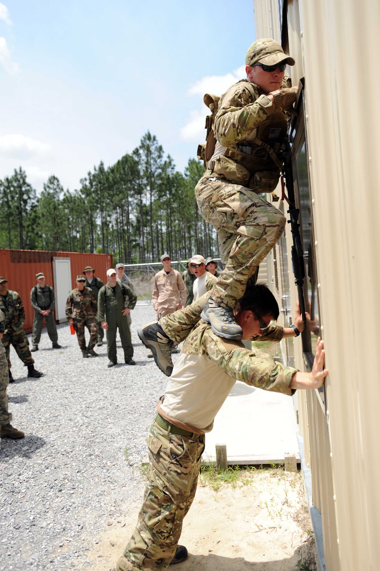 Survival, Evasion, Resistance and Escape specialists demonstrate to Airmen how to enter a window on the second floor of a building during combat skills training at an undisclosed location within the Eglin Range, Fla., May 13, 2010.  SERE specialists are able to utilize the multitude of resources and experiences from their fellow 1st Special Operations Support Squadron Range Support flight to prepare Airmen for situations that may happen in combat. (DoD photo by U.S. Air Force Senior Airman Matthew Loken/Released)