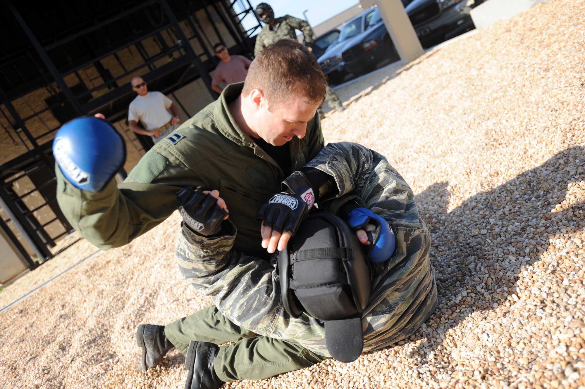 A Hurlburt Airman participating in Survival, Evasion, Resistance, and Escape live conflict training, punches a padded-up SERE specialist during combat skills training outside the SERE training center at Hurlburt Field, Fla., May 13, 2010.  SERE specialists are able to utilize the multitude of resources and experiences from their fellow 1st Special Operations Support Squadron Range Support flight to prepare Airmen for situations that may happen in combat. (DoD photo by U.S. Air Force Senior Airman Matthew Loken/Released)