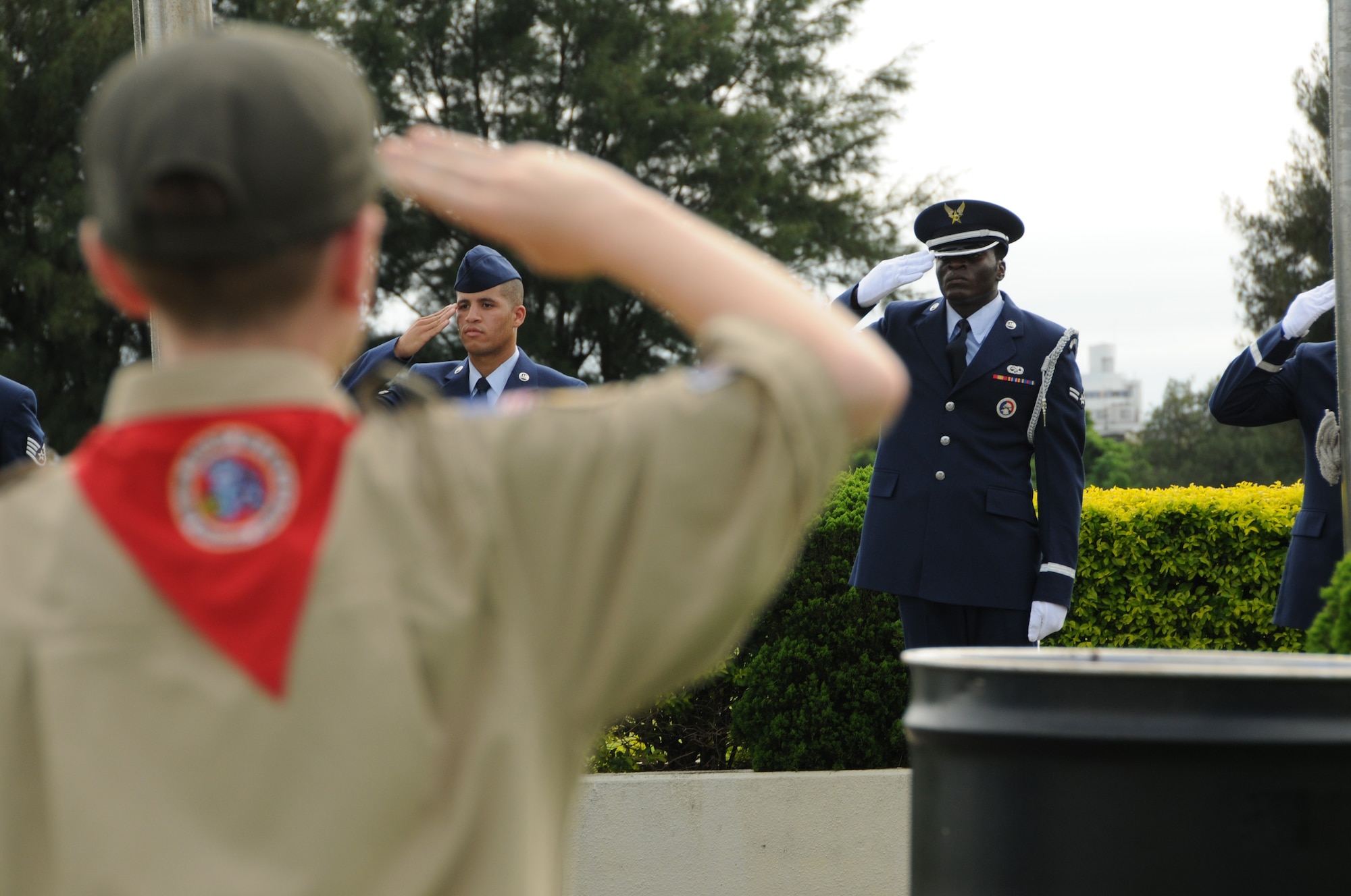 Kadena Airmen as well as Cub Scouts render a salute to the flag while reciting the Pledge of Allegiance during the 2010 Air Force Sergeants Association’s Flag Day Ceremony, June 14. During this ceremony, unserviceable flags were retired honorably by being burned. (U.S. Air Force photo/ Airman 1st Class Jarvie Wallace)