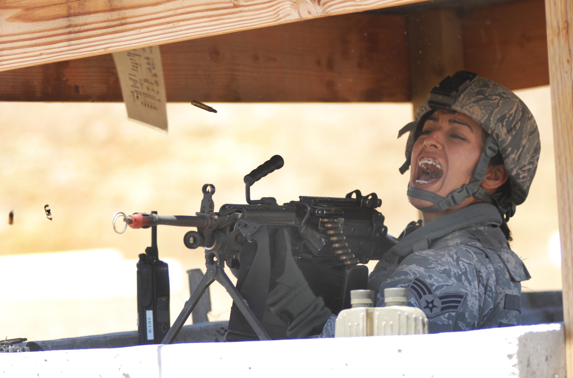 VANDENBERG AIR FORCE BASE, Calif. - Challenging opposition forces, Senior Airman Norma Alvarez, of the 30th Security Forces Squadron, fires her M249 light machine gun during a North Star exercise here Thursday, June 10, 2010. At the North Star exercise, Airmen are taught to positively identify the enemy during an attack before firing their weapon. (U.S. Air Force photo/Senior Airman Christopher 
Hubenthal)

