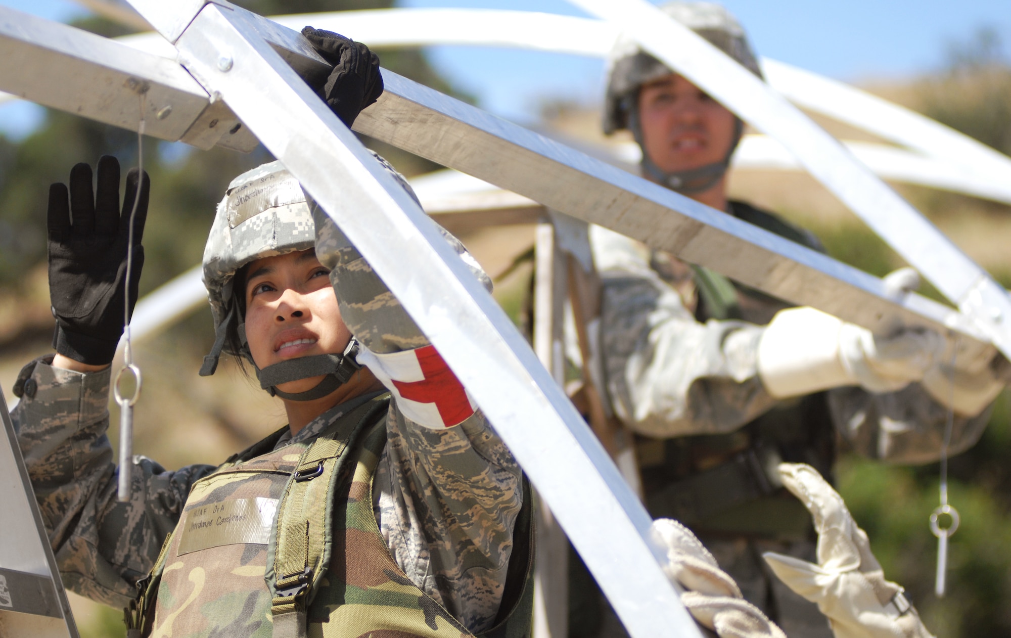 VANDENBERG AIR FORCE BASE, Calif. - Senior Airman Jhordimae Cardenas, of the 30th Medical Support Squadron, helps her team construct the medical tent for the North Star exercise here Thursday, June 10, 2010. The beginning of the North Star exercise is focused on safety briefing and construction of the simulated camp (U.S. Air Force photo/Senior Airman Christopher Hubenthal)

