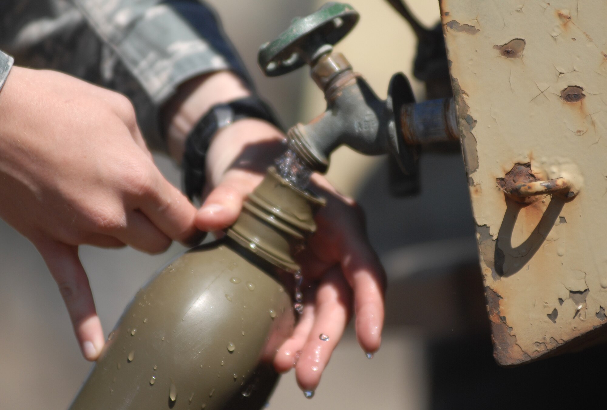 VANDENBERG AIR FORCE BASE, Calif. - An Airman of Team V fills her canteen with water during the North Star exercise here Thursday, June 10, 2010. The North Star exercise lasts two days and includes fundamentals training, processing a simulated deployment line and two days in the field. (U.S. Air Force photo/Senior Airman Christopher Hubenthal)

