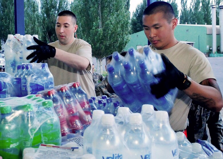 Airmen from the Transit Center at Manas load food onto a pallet at the Manas International Airport in Kyrgyzstan June 13, 2010, for transportation to Osh, Kyrgyzstan. Transit Center and Department of State officials purchased flour, oil, pasta, tea, yeast, and other basics totaling more than 31,000 pounds for a humanitarian assistance delivery to the southern region of Osh. (U.S. Air Force photo/Senior Airman Nichelle Anderson)
