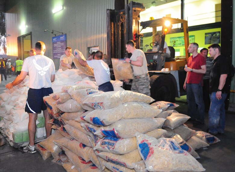 Airmen from the Transit Center at Manas load food onto a pallet at the Manas International Airport in Kyrgyzstan June 13, 2010, for transportation to Osh, Kyrgyzstan. Transit Center and Department of State officials purchased flour, oil, pasta, tea, yeast, and other basics totaling more than 31,000 pounds for a humanitarian assistance delivery to the southern region of Osh. (U.S. Air Force photo/Senior Airman Nichelle Anderson)