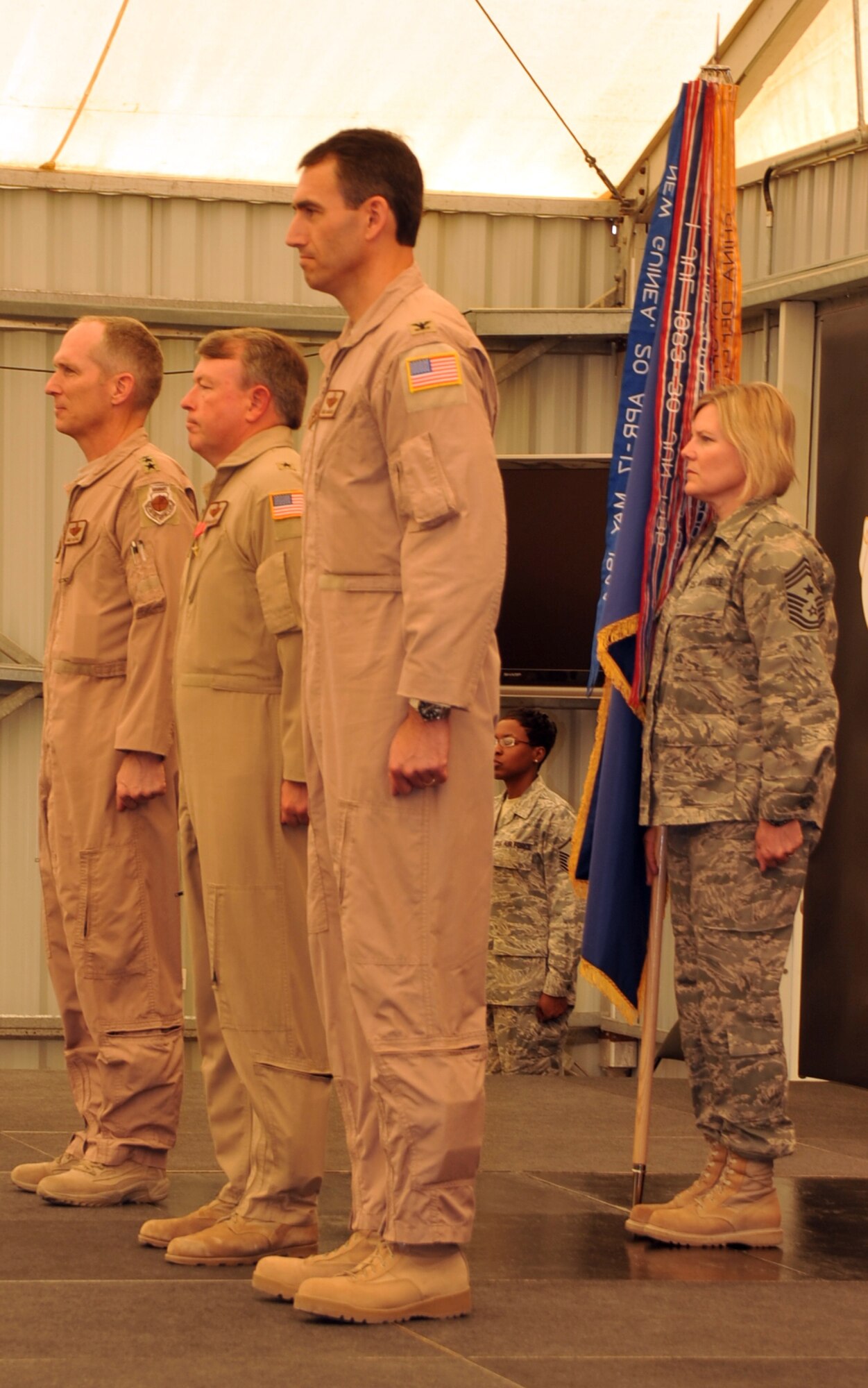 Lt. Gen. Mike Hostage, U.S. Air Forces Central Command commander in Southwest Asia, Brig. Gen. Bryan Benson, former 380th Air Expeditionary Wing commander, Col. Mike Minahan, newest 380th AEW commander, and Chief Master Sgt. Suzan Sangster, 380th AEW command chief master sergeant, participate in the 380th AEW change of command ceremony at a non-disclosed base in Southwest Asia on June 14, 2010. During the ceremony, Colonel Minahan took command of the 380th AEW from General Benson. (U.S. Air Force Photo/Master Sgt. Scott T. Sturkol/Released)