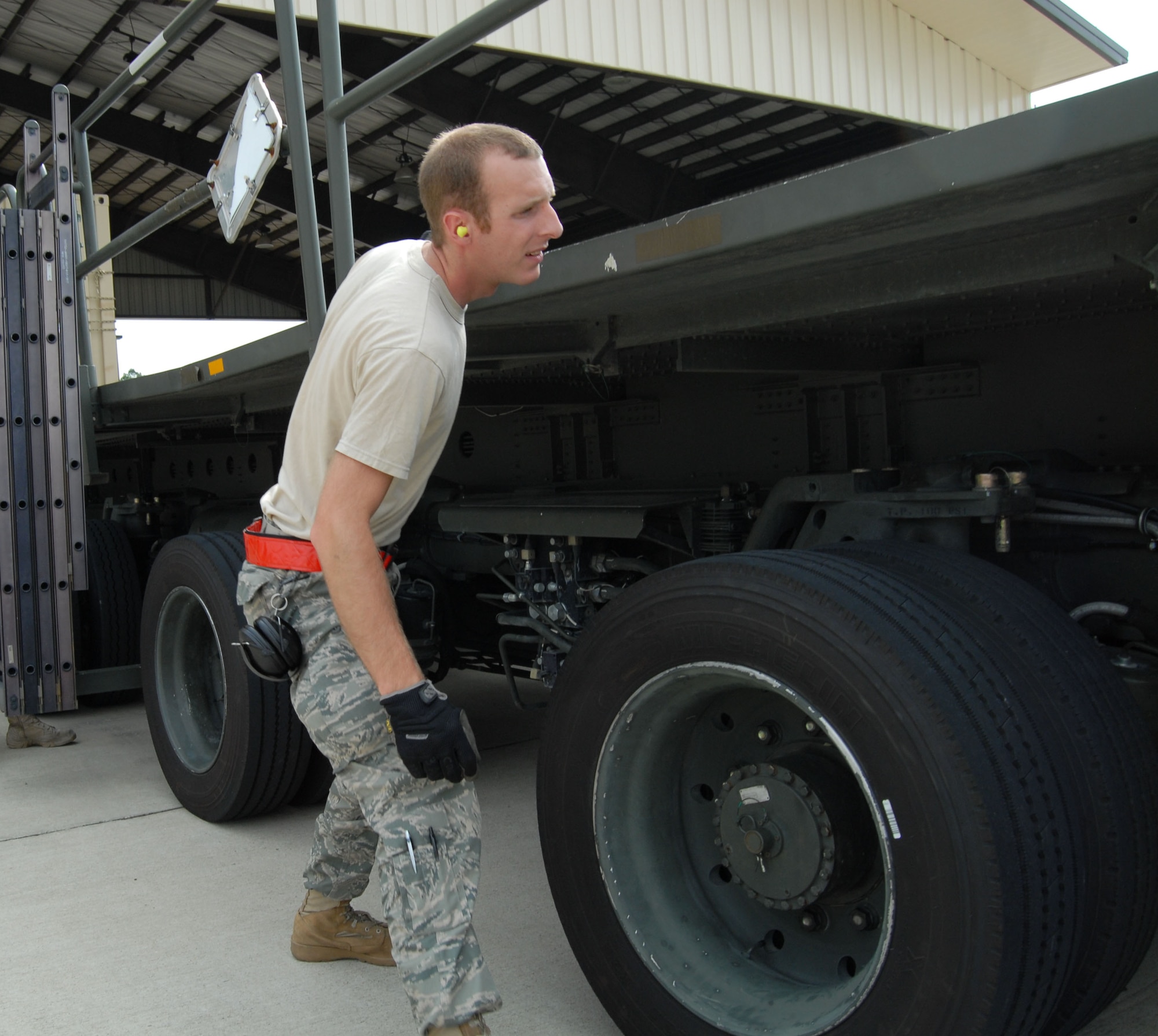 Staff Sgt. Jedidiah Coover, 3rd Aerial Port Squadron, inspects the tire wells of a K-loader prior to loading pallets in preparation for the upcoming Logistics Compliance Assessment Program inspection. The LCAP is scheduled for June 14 through 19. (U.S. Air Force Photo/1st Lt. Cammie Quinn)