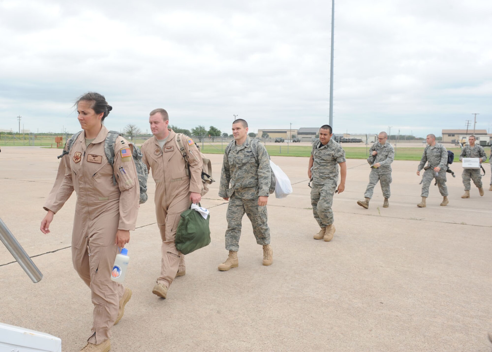 DYESS AIR FORCE BASE, Texas--Dyess Airmen board a plane June 14 here. More than 150 Airmen deployed to Southwest Asia in support of Operation Enduring Freedom. The Airmen will be deployed for four months, and will return in October. (U.S Air Force photo/ Airman 1st Class Shannon Hall) 