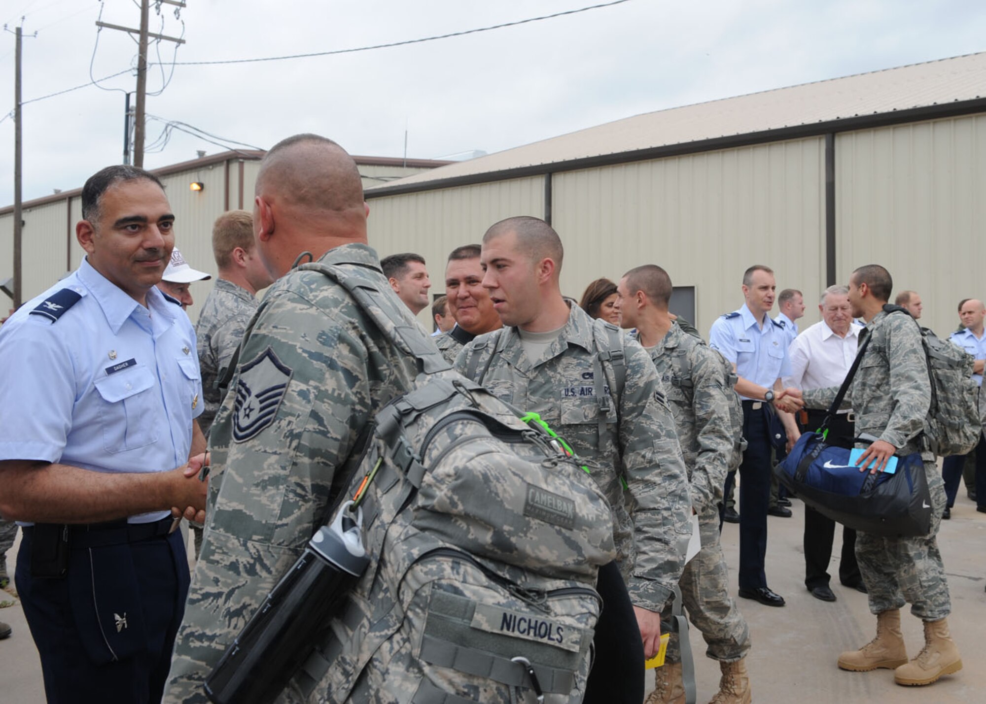 DYESS AIR FORCE BASE, Texas--Dyess Airmen shake hands and bid farewell to co-workers June 14 here. More than 150 Airmen deployed to Southwest Asia in support of Operation Enduring Freedom. The Airmen will be deployed for four months, and will return in October. (U.S Air Force photo/ Airman 1st Class Shannon Hall)