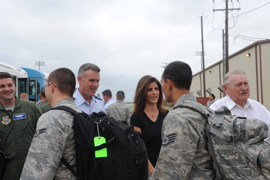 DYESS AIR FORCE BASE, Texas--Col. Robert Gass, 7th Bomb Wing commander, and his wife, Patty, shake hands with Dyess Airmen leaving for deployment June 14 here. More than 150 Airmen deployed to Southwest Asia in support of Operation Enduring Freedom. The Airmen will be deployed for four months, and will return in October. (U.S Air Force photo/ Airman 1st Class Shannon Hall)