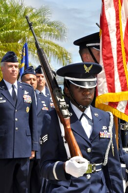 Col. Robert "Randy" Huston, 624th Regional Support Group commander and official party, watch as base honor guard post the colors at  the 48th Aerial Port Squadron's change of command ceremony held at Aloha Aina Park, Joint Base Pearl Harbor Hickam, Hawaii, June 12, 2010. (U.S. Air Force photo/Master Sgt. Daniel Nathaniel III)