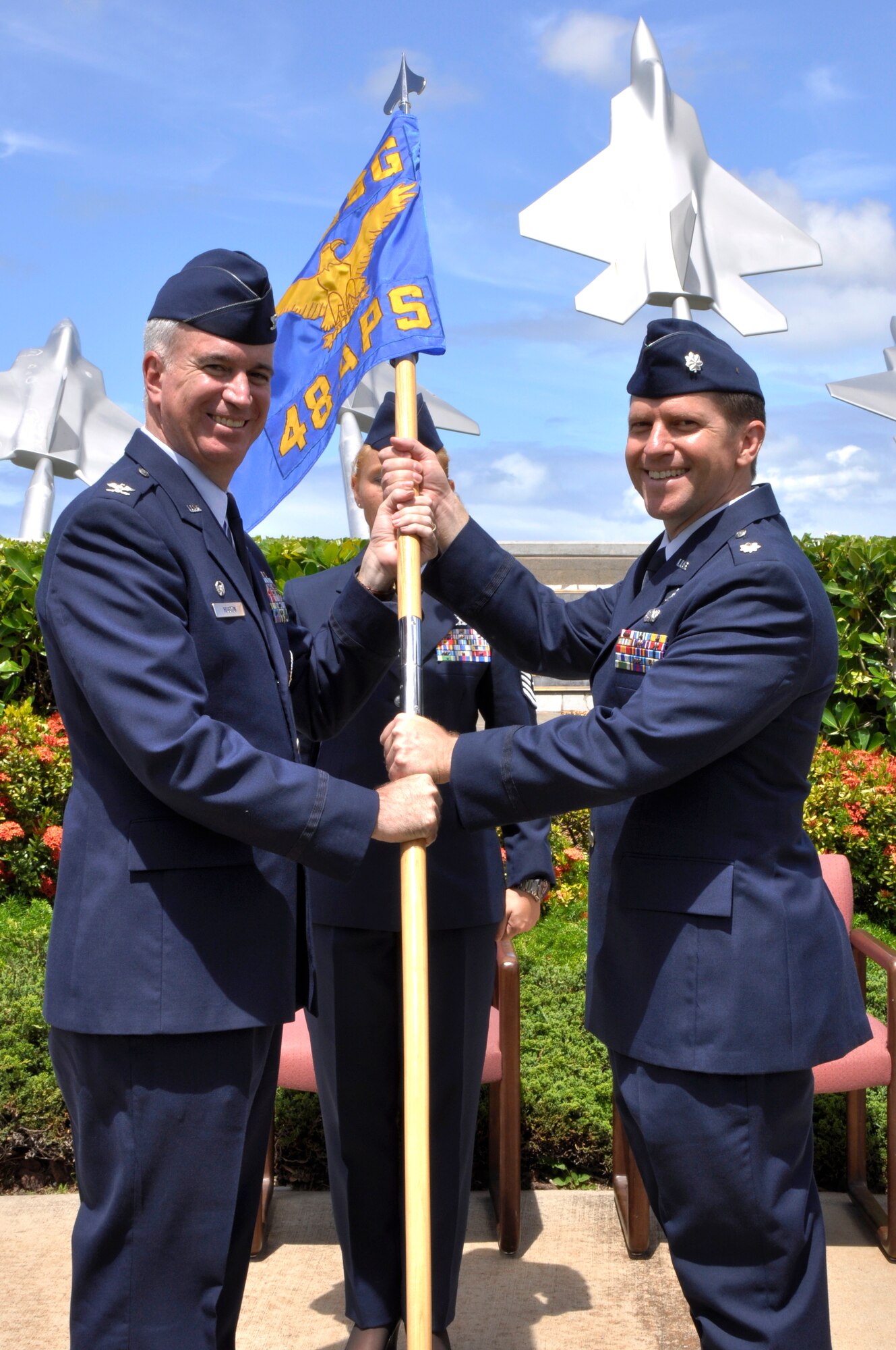 Col. Robert “Randy” Huston, 624th Regional Support Group commander, passes the 48th Aerial Port Squadron guidon to incoming commander Lt. Col. Eric Peebles, during a change of command ceremony held at Aloha Aina Park, Joint Base Pearl Harbor Hickam, Hawaii, June 12, 2010. (U.S. Air Force photo/Master Sgt. Daniel Nathaniel III)