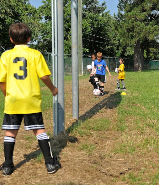 MOODY AIR FORCE BASE, Ga. -- Children practice passing a soccer ball back and forth during a Major League Soccer camp here June 11. The camp is based on various drills used to develop basic soccer techniques. (U.S. Air Force photo by Airman 1st Class Joshua Green/RELEASED)