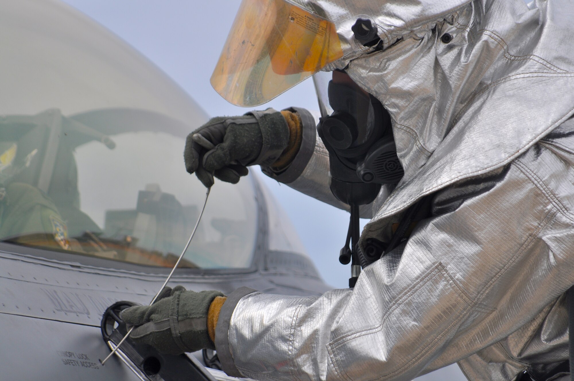 Firefighter Master Sgt. Nolan Smith, 419th Civil Engineer Squadron, releases the canopy lock to allow the canopy to be opened from the outside. (U.S. Air Force photo/Staff Sgt. Kyle Brasier)