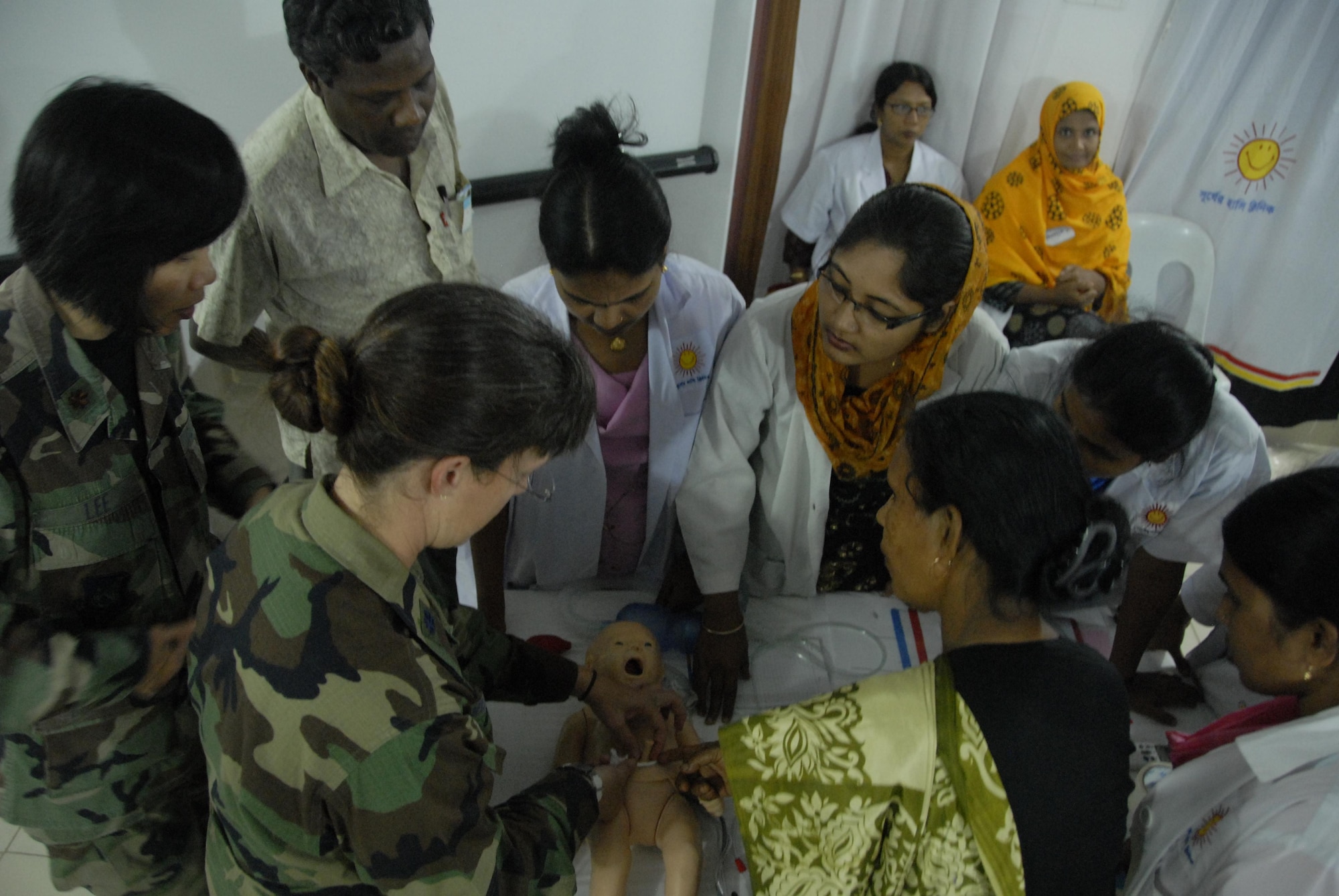 Lt. Col. Lindy Winter, Chief of Neonatology at the U.S. Naval Hospital on Camp Lester in Okinawa, Japan, demonstrates procedures on an infant's umbilical cord with Bangladeshi health care providers during a subject matter expert exchange at the Smiling Sun Clinic in Jessore, Bangladesh June 12. Operation Pacific Angel is a joint and combined humanitarian assistance operation conducted in the Pacific area of responsibility to support U.S. Pacific Command's capacity-building efforts. This humanitarian and civic assistance program is aimed at improving military civic cooperation between the United States and countries throughout the Asia-Pacific region. The exchange was part of Pacific Angel 10-3, which will be held in Bangladesh through June 16. (U.S. Air Force photo by 1st Lt. Chris Hoyler) 