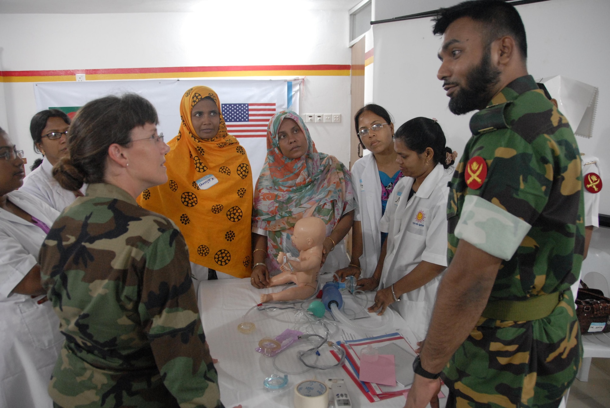 Lt. Col. Lindy Winter, left, Chief of Neonatology at the U.S. Naval Hospital on Camp Lester in Okinawa, Japan, and Maj. Mofazzol Hossain, Bangladesh Army pediatrician, prepare for a neonatal care scenario with Bangladeshi health care providers at the Smiling Sun Clinic in Jessore, Bangladesh June 12. Operation Pacific Angel is a joint and combined humanitarian assistance operation conducted in the Pacific area of responsibility to support U.S. Pacific Command's capacity-building efforts. This humanitarian and civic assistance program is aimed at improving military civic cooperation between the United States and countries throughout the Asia-Pacific region. The scenario was part of a subject matter expert exchange on neonatal care taking place over two days during Pacific Angel 10-3. (U.S. Air Force photo by 1st Lt. Chris Hoyler) 