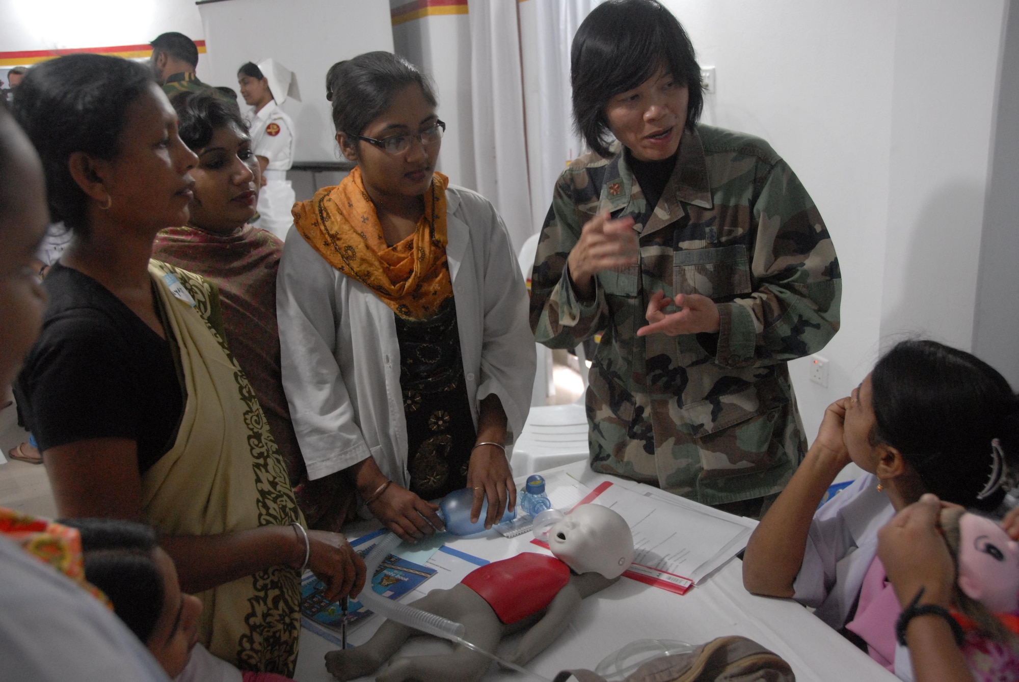Maj. Chung Lee, nurse and international health specialist for 13th Air Force at Hickam Air Force Base, Hawaii, discusses resuscitative measures for infants with Bangladeshi health care providers during a subject matter expert exchange at the Smiling Sun Clinic in Jessore, Bangladesh June 12. Operation Pacific Angel is a joint and combined humanitarian assistance operation conducted in the Pacific area of responsibility to support U.S. Pacific Command's capacity-building efforts. This humanitarian and civic assistance program is aimed at improving military civic cooperation between the United States and countries throughout the Asia-Pacific region. The exchange was part of Pacific Angel 10-3, which will be held in Bangladesh through June 16. (U.S. Air Force photo by 1st Lt. Chris Hoyler) 