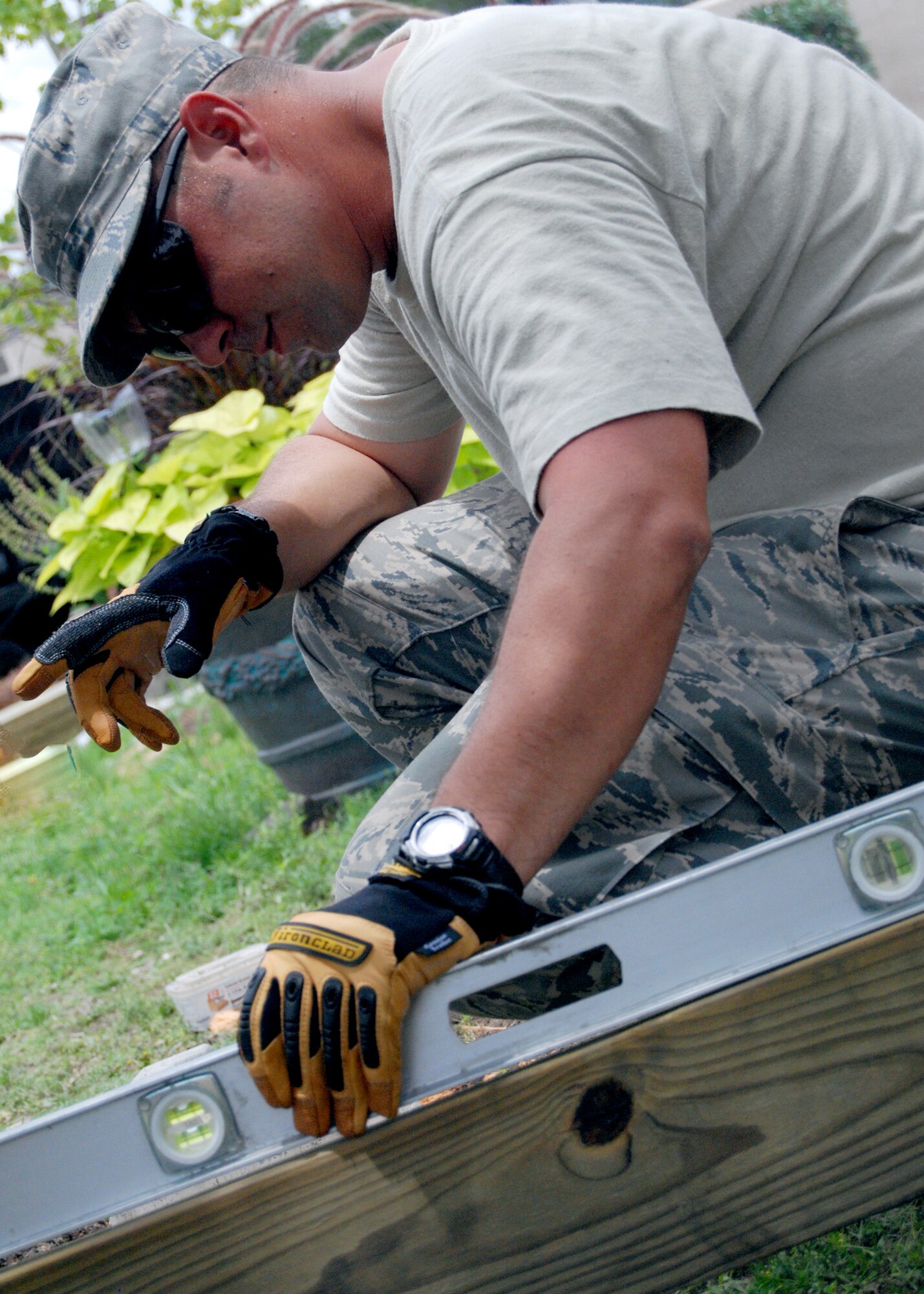 Air Force Reserve Tech. Sgt. Jeremy McCartney, 919th Civil Engineer Squadron, ensures the beams are level for the frame of a deck project at Hurlburt Field, Fla. Members of the Duke Field, Fla., squadron built a deck June 3-4 for  the Children’s Learning Center as part of the “Nature Explore Classroom.” (U.S. Air Force photo/Tech. Sgt. Cheryl Foster)