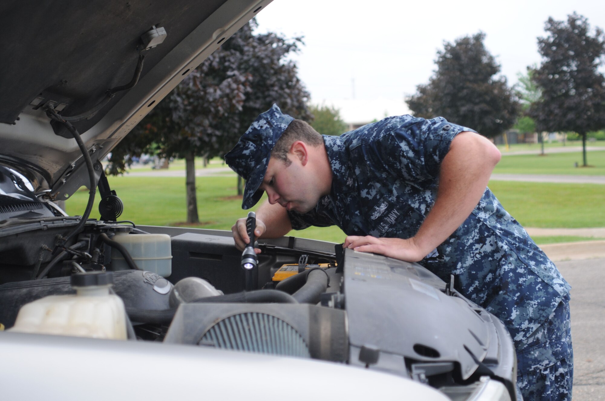 U.S. Navy Petty Officer 2nd Class Kirk Cornell, Naval Operations Support Center Battle Creek, Mi., inspects a vehicle at the 110th Airlift Wing Air National Guard Base Battle Creek, Mi., June 6, 2010. Cornell was working with 110th Security Forces Squadron for additional training and to augment with security forces. (U.S. Air Force photo by Tech. Sgt. David Eichaker/released)