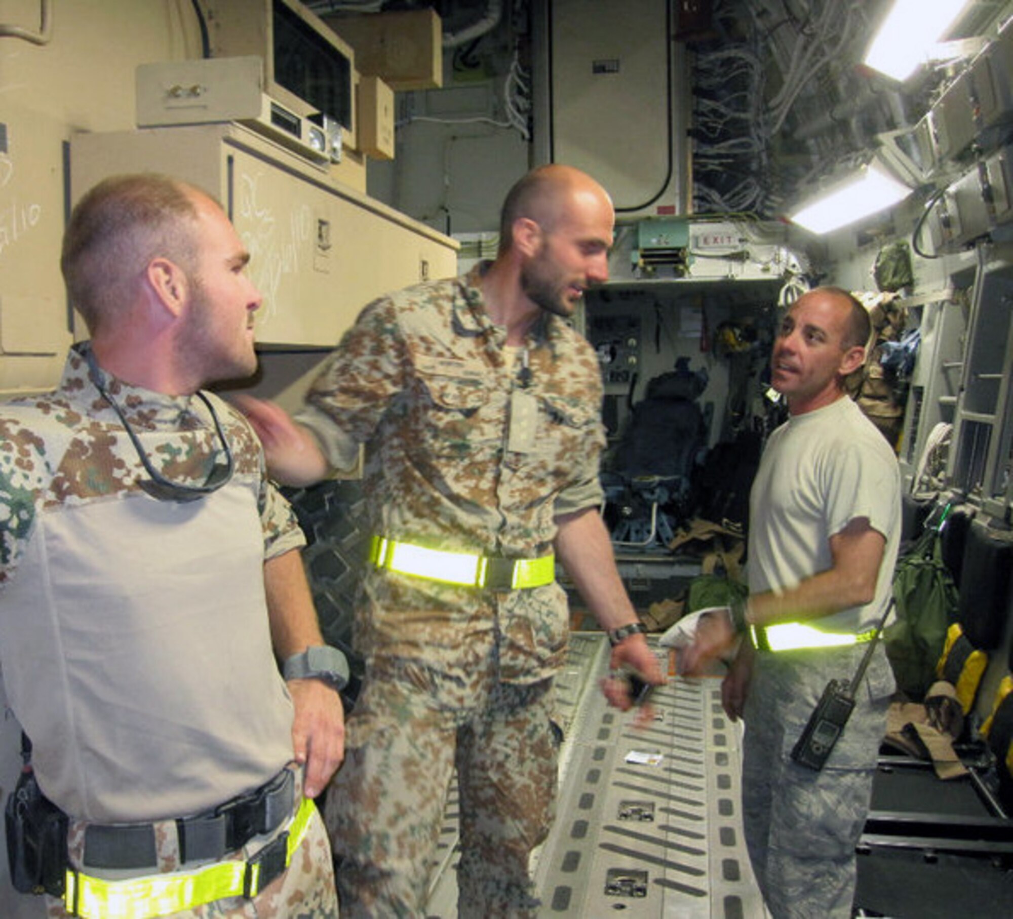 Staff Sgt. John Fitzgerald, (far right) deployed from Pope’s 3rd Aerial Port Squadron, speaks with Danish service members during his deployment to Camp Bastion, Afghanistan. Sergeant Fitzgerald deployed to Camp Bastion in January 2010, and serves as the passenger service non commissioned officer-in-charge. (U.S. Air Force Photo/ Courtesy) 