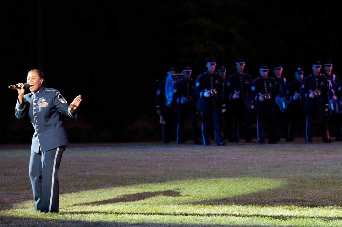 Master Sgt. Regina Coonrod, U.S. Air Force Band,  Max Impact performs the song "Reach" in Spanish June 13 at the Twilight Tattoo held at the U.S. Air Force Ceremonial Lawn on Bolling Air Force Base. Gen Norton A. Schwartz, U.S. Air Force chief of staff, hosted the event celebrating "50 Years of Friendship and Cooperation" between nations belonging to the System of Cooperation among American Air Forces. (U.S. Air Force photo by Staff Sgt. Raymond Mills)
