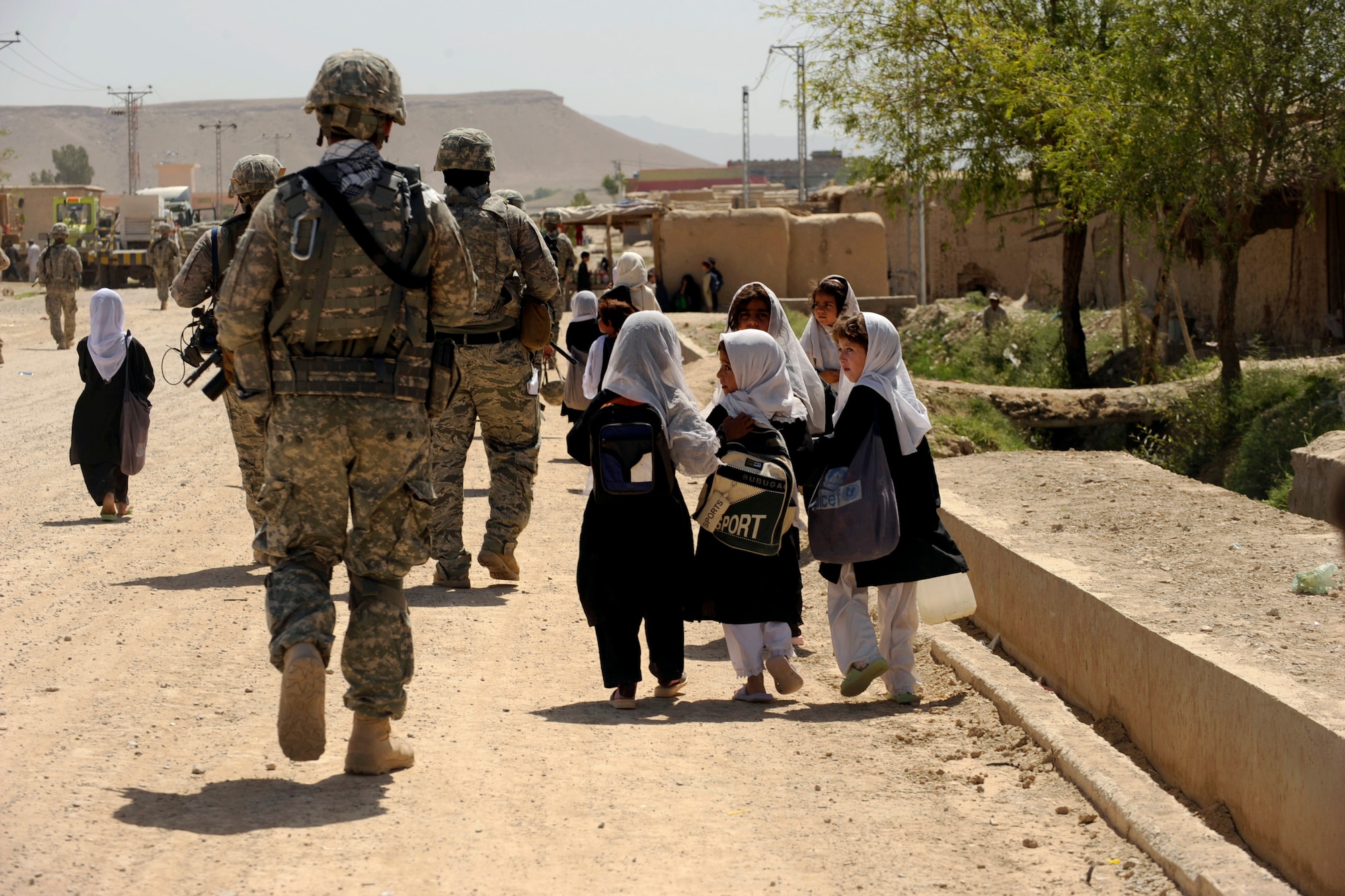 Afghan students from the Bibi Khala Girls School walk home after a day of school alongside Soldiers and Airmen assigned to Provincial Reconstruction Team Zabul May 31, 2010, in Qalat City, Afghanistan. (U.S. Air Force photo/Staff Sgt. Manuel J. Martinez)