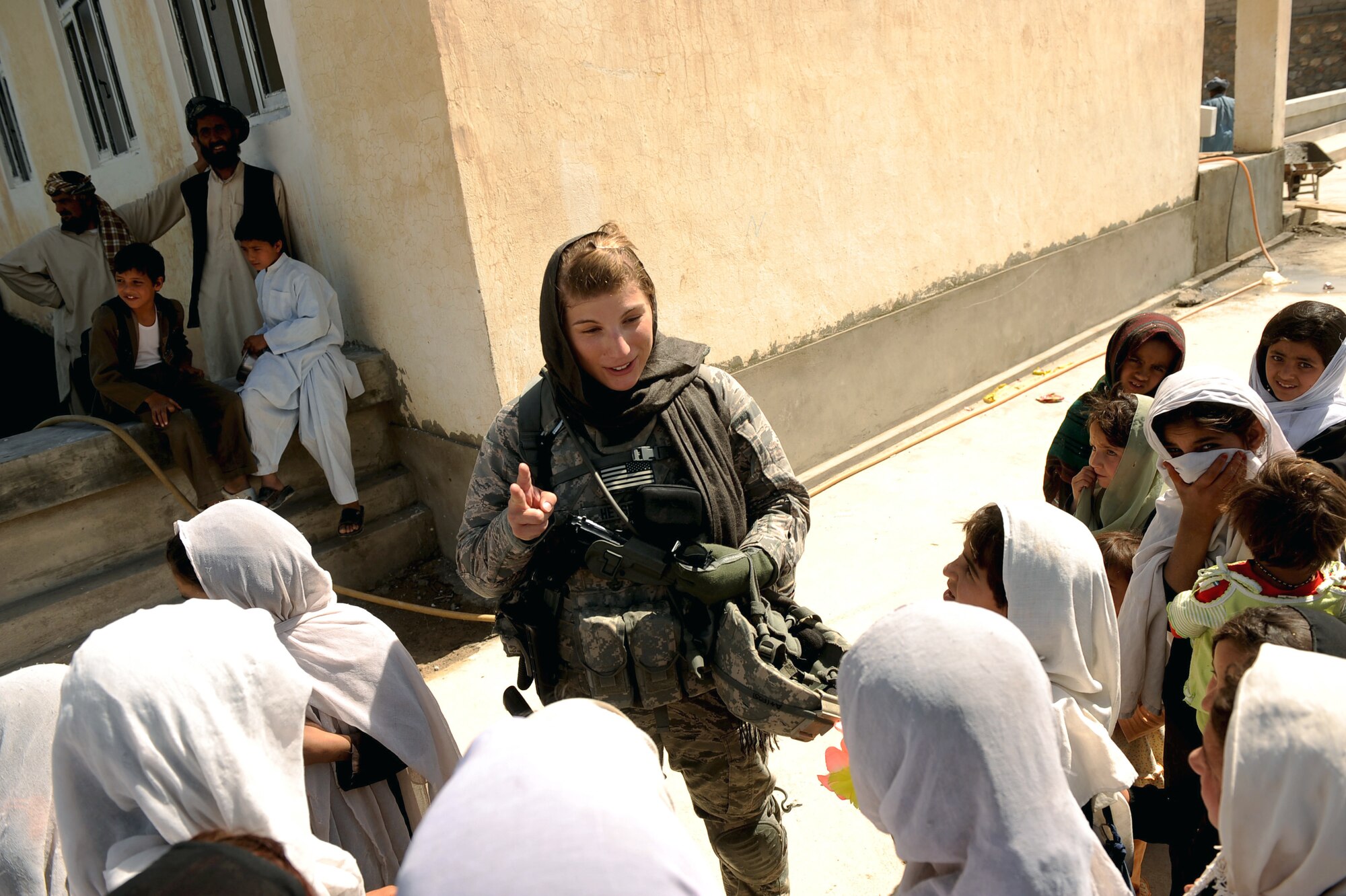 1st Lt. Rebecca Heyse sings the "ABC" song with some of the students of the Bibi Khala Girls School May 31, 2010, in Qalat City, Afghanistan. Lieutenant Heyse is an information officer assigned to Provincial Reconstruction Team Zabul. (U.S. Air Force photo/Staff Sgt. Manuel J. Martinez)