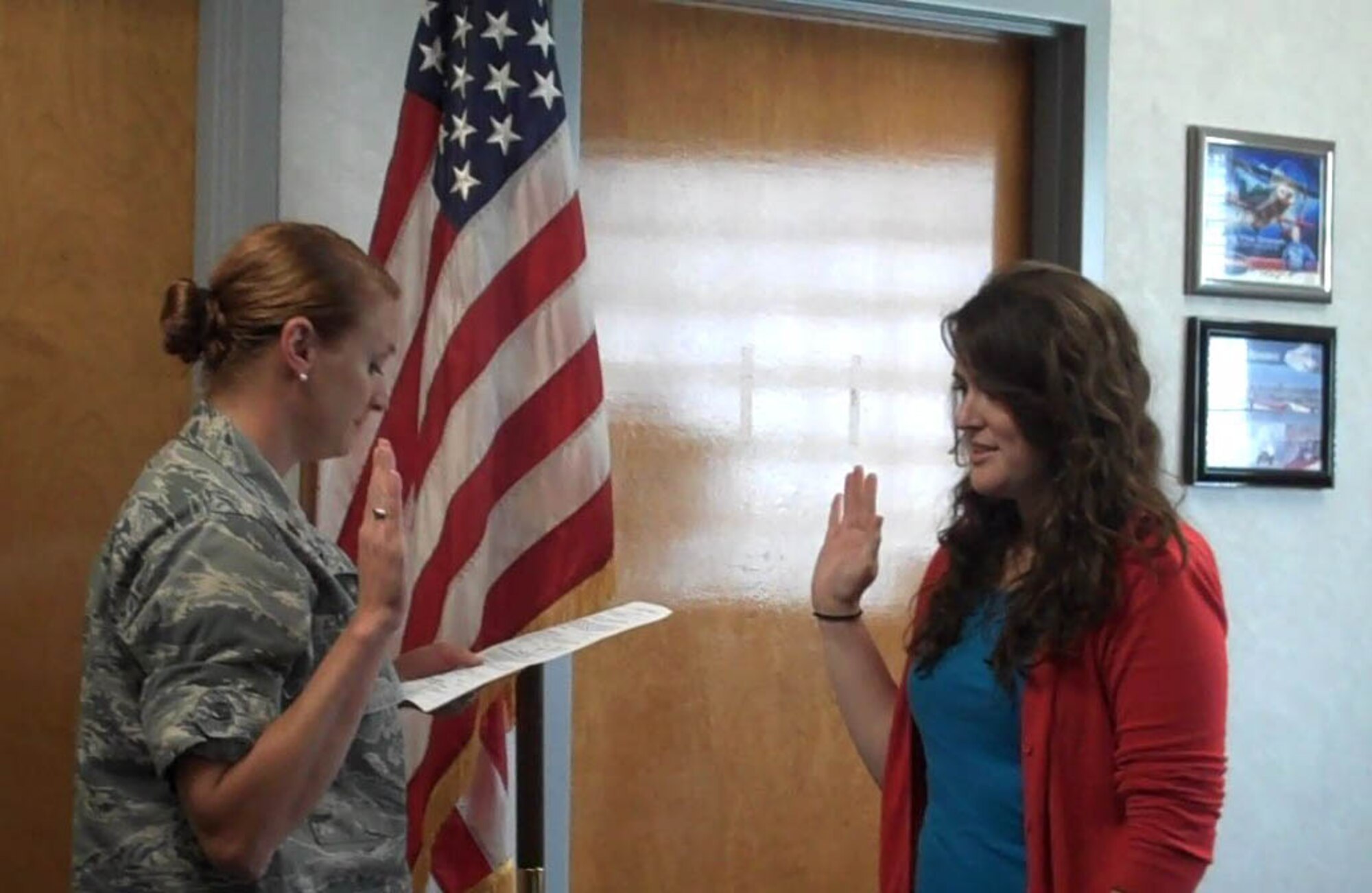 Ms. Meredith Thomas, right, takes the oath of enlistment in late May to join the 916th Air Refueling Wing, Air Force Reserve. Ms. Thomas is assigned to the 916th Public Affairs Office. (USAF courtesy photo)