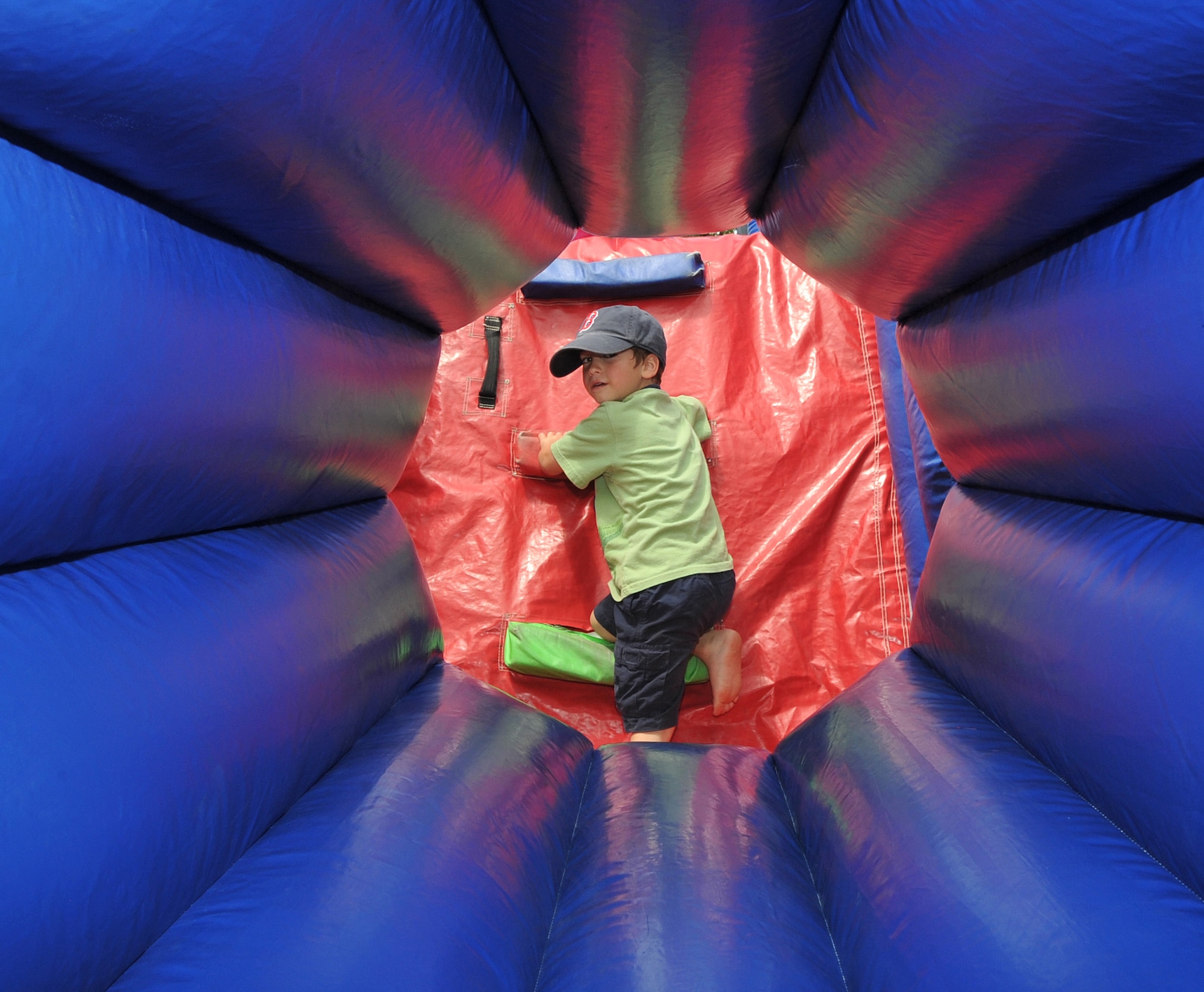 OFFUTT AIR FORCE BASE, Neb. - Four-year-old Jordan Harris, son of  Lt. Cmdr. Jeff Harris a member of U.S. Strategic Command, looks back before he climbs one of the many inflatables at the Offutt Advisory Council's Annual Offutt Appreciation Picnic June 11 at the base lake. During the event, Team Offutt members enjoyed a day in the sun filled with free food, beverages and entertainment. U.S. Air Force photo by Jeff W. Gates 