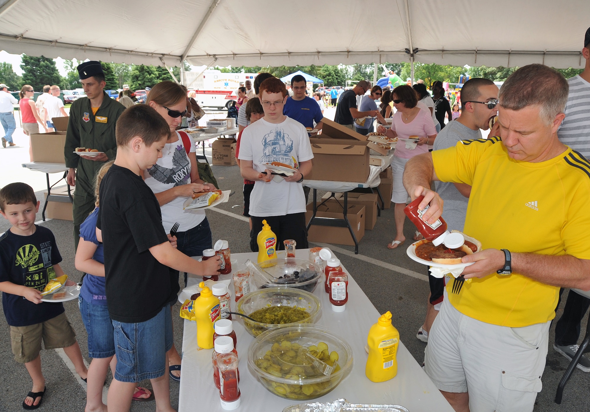 OFFUTT AIR FORCE BASE, Neb. - Team Offutt members grab lunch during the Offutt Advisory Council's Annual Offutt Appreciation Picnic June 11 at the base lake.  During the event, Offutt employees and their families enjoyed a day of free food, beverages and entertainment courtesy of the community support organization. U.S. Air Force photo by Jeff W. Gates 