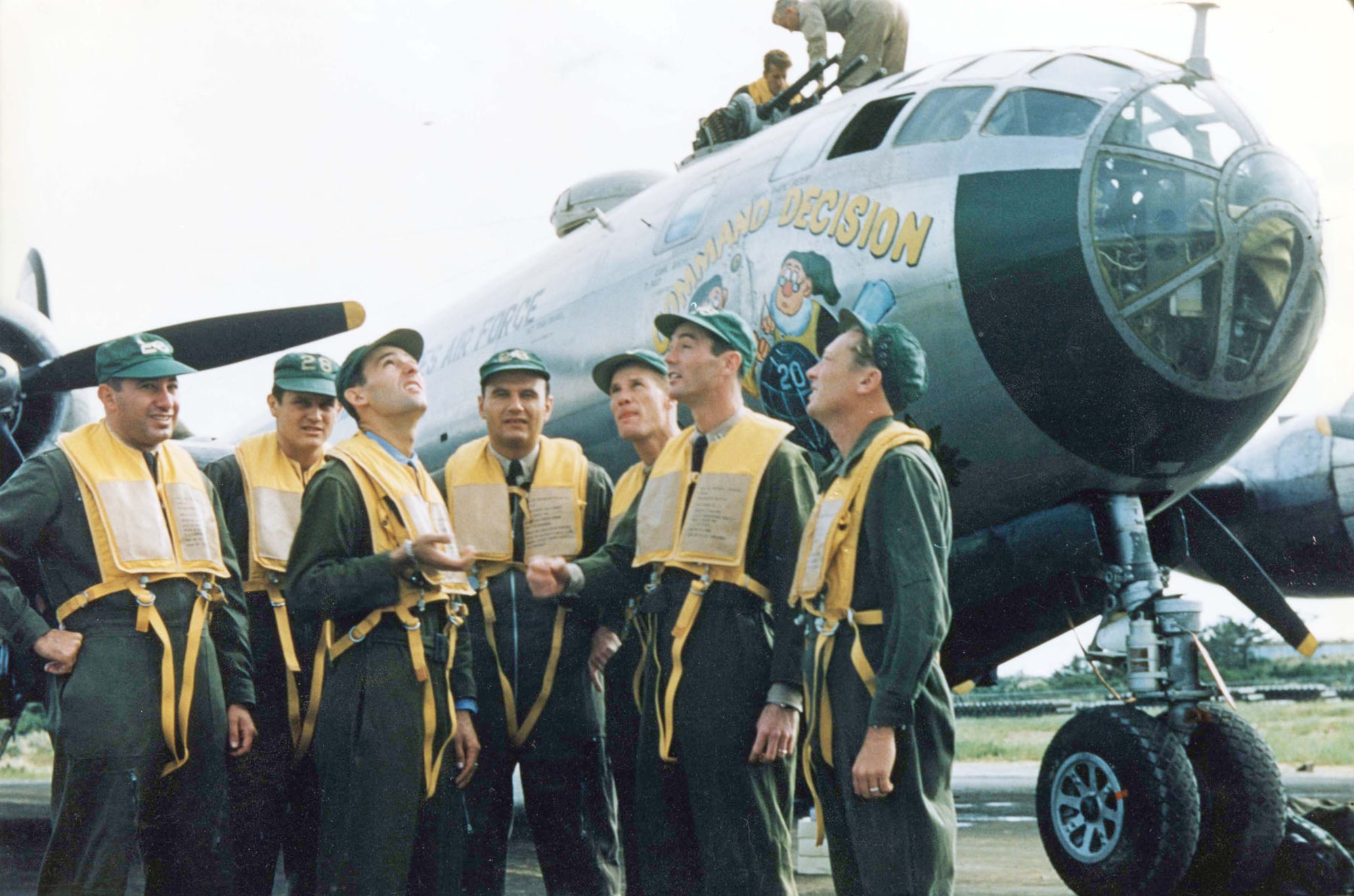 Capt. Donald M. Covic makes a “command decision” by flipping a coin, just like the artwork on his B-29. (U.S. Air Force photo)