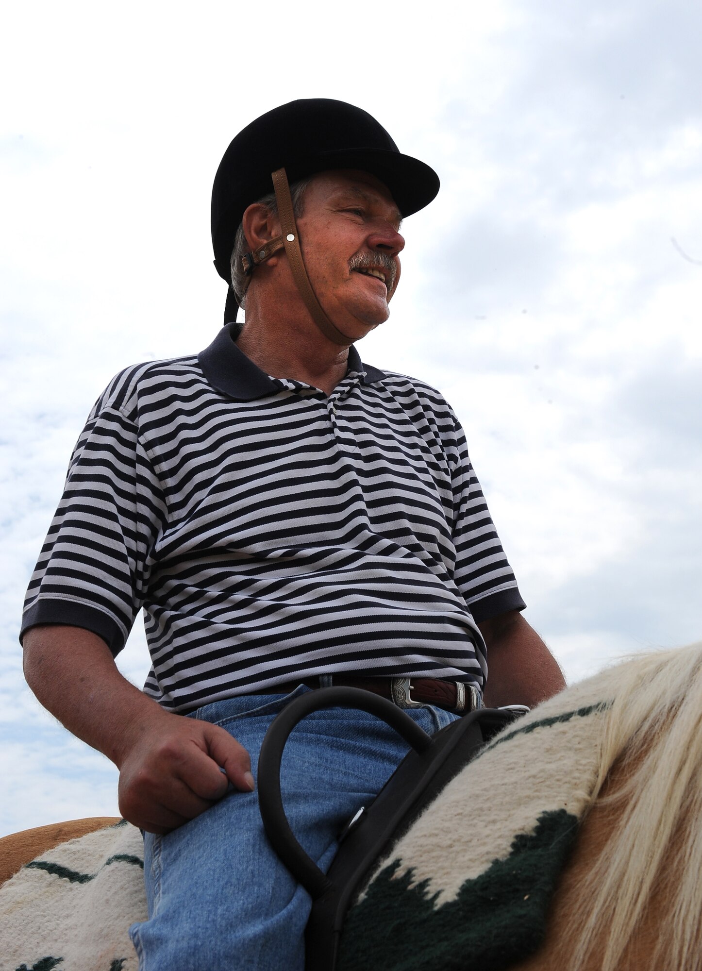 LANGLEY AIR FORCE BASE, Va. -- Terry “Tom” Steele rides “Buddy” the horse during a Horses Helping Heroes therapy session June 3. Therapy ranges from simply sitting atop the horse to walking, trotting and brushing the horse. (U.S. Air Force photo/Senior Airman Gul Crockett)