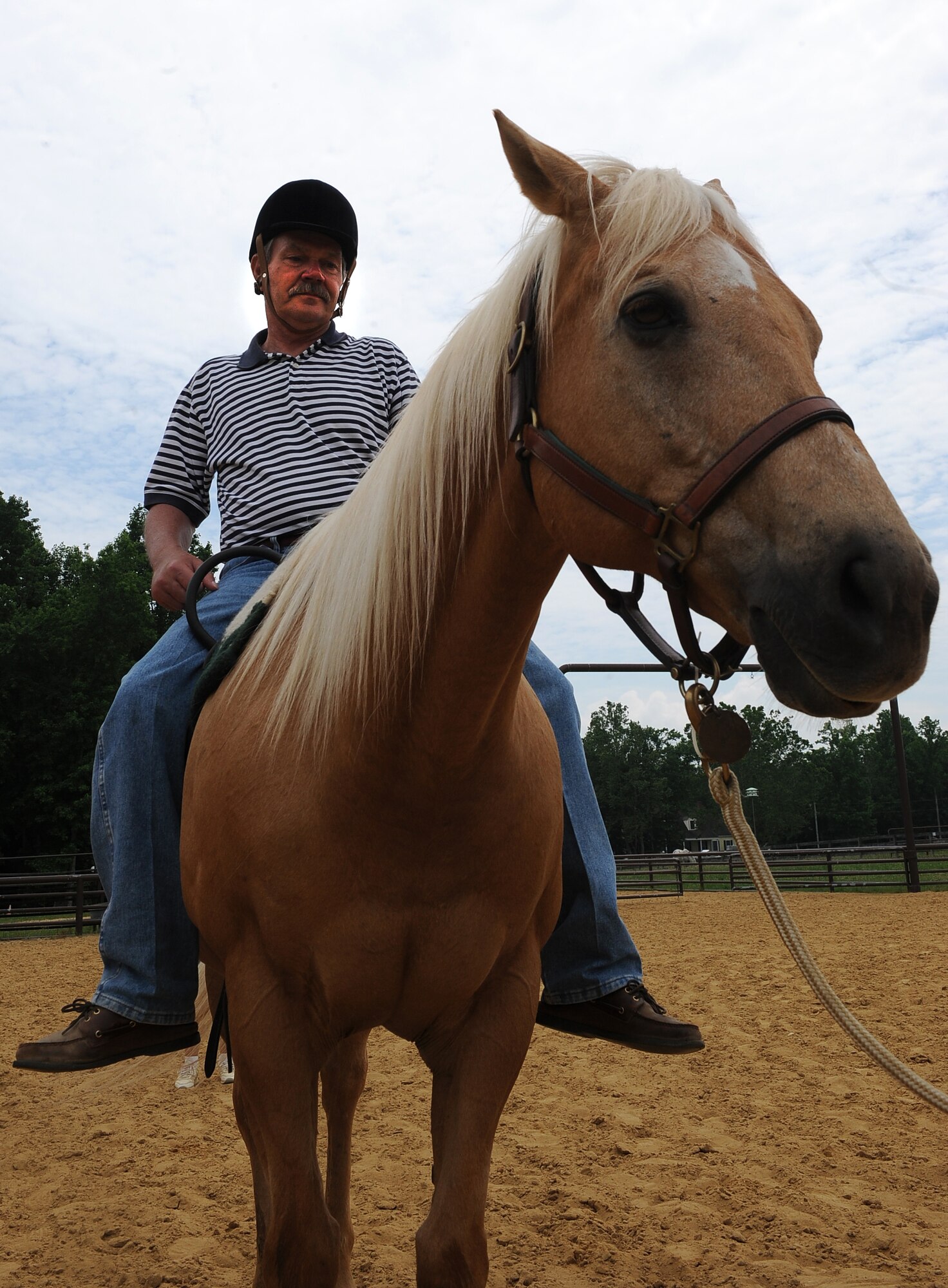 LANGLEY AIR FORCE BASE, Va. -- Terry “Tom” Steele rides “Buddy” the horse during a Horses Helping Heroes therapy session June 3. The project is a groundbreaking program providing therapy to persons with severe physical impairments, including military veterans. (U.S. Air Force photo/Senior Airman Gul Crockett)