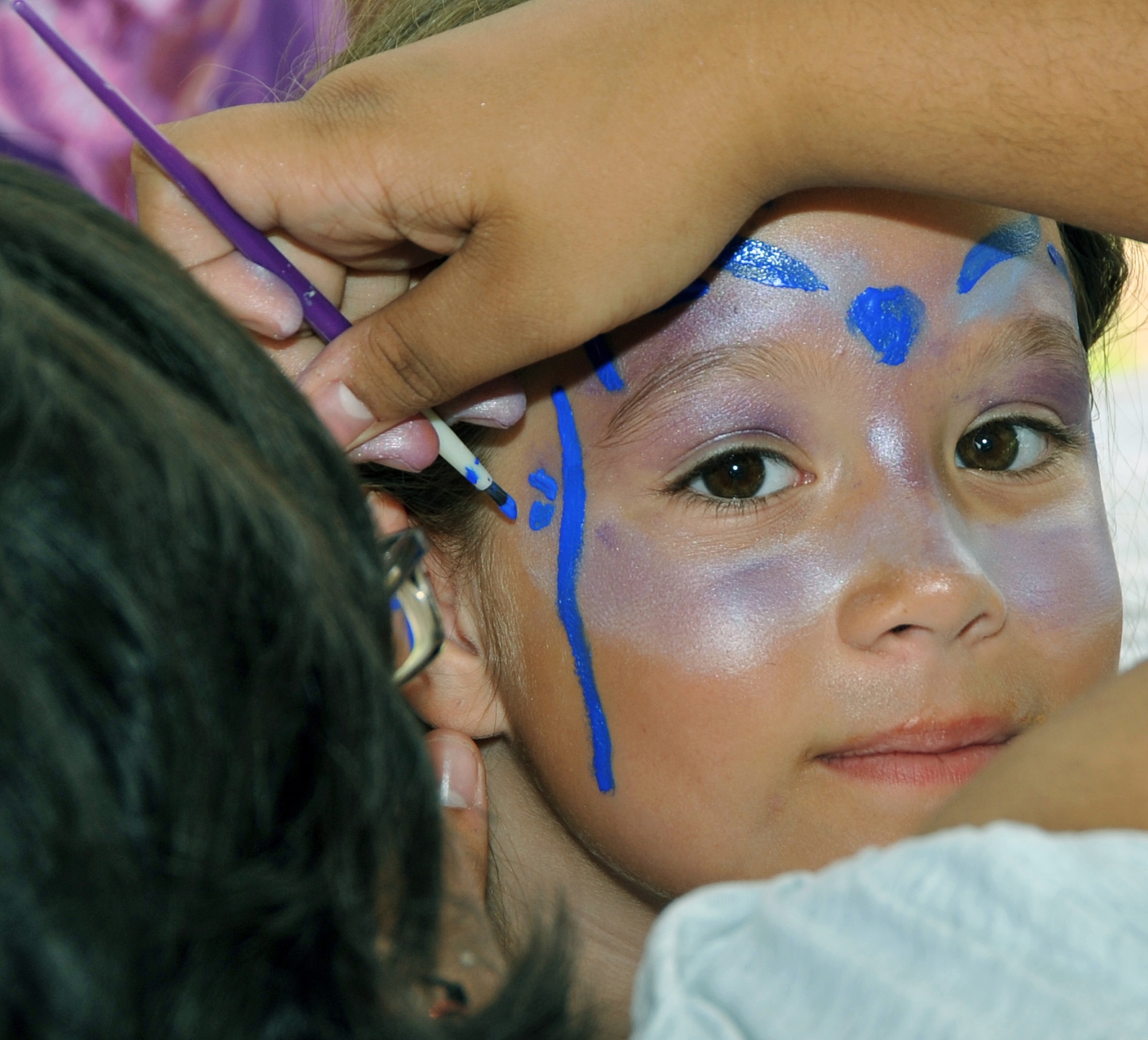 OFFUTT AIR FORCE BASE, Neb. - Eight-year-old Cathy Shawhan, daughter of Col. Buck Shawhan, a member of U.S. Strategic Command, gets her face painted during the Offutt Advisory Council's Annual Offutt Appreciation Picnic June 11. Team Offutt members enjoyed a day at the base lake filled with free food, beverages and entertainment. U.S. Air Force photo by Jeff W. Gates 