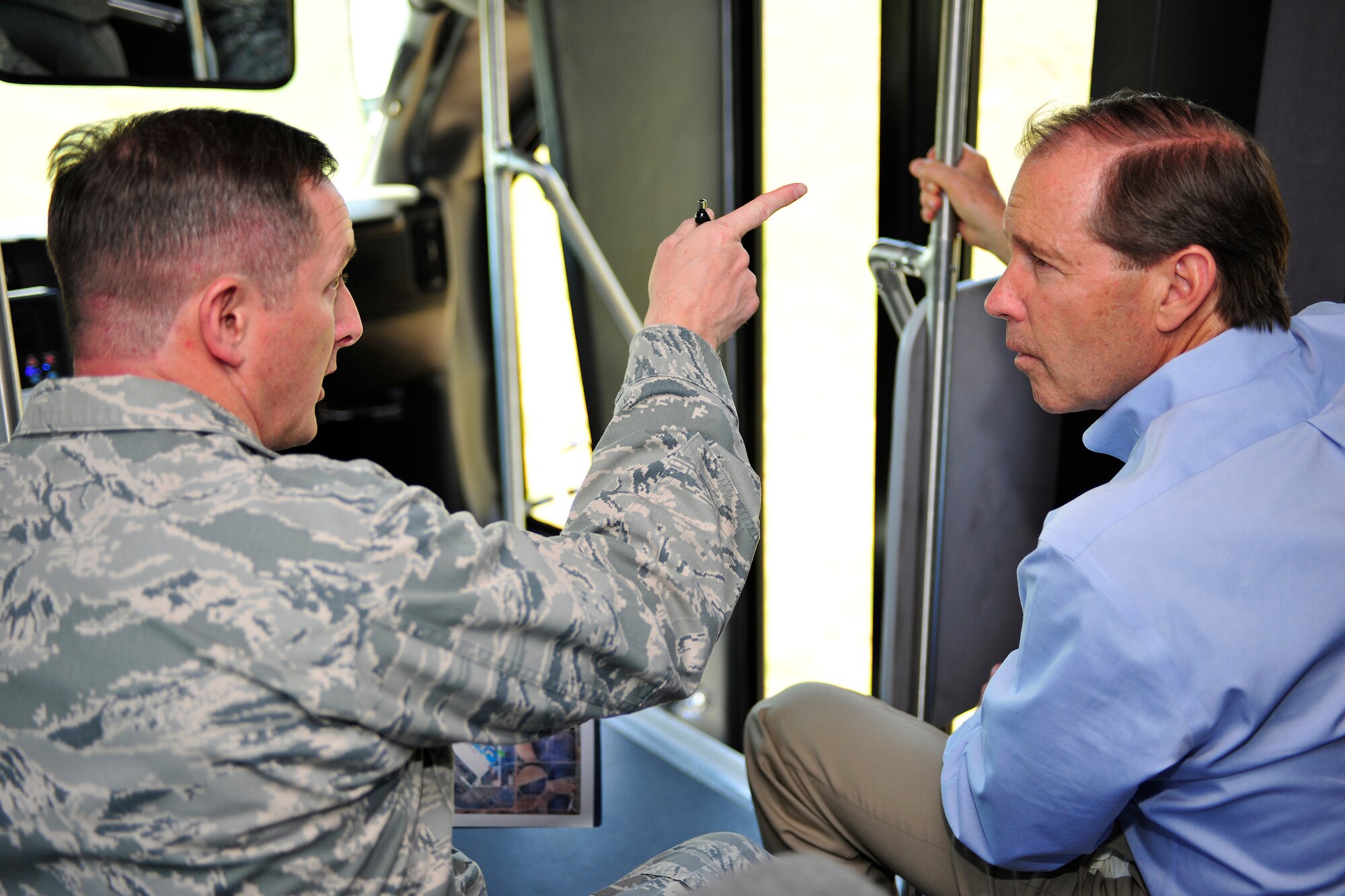 Col. Stephen Clark, 27th Special Operations Wing commander, highlights points of interest to U.S. Sen. Tom Udall, D-NM, during a tour of Cannon Air Force Base. Sen. Udall viewed recent and planned construction sites at the base during a brief visit June 10.  (US Air Force Photo by Technical Sgt. Josef Cole) 