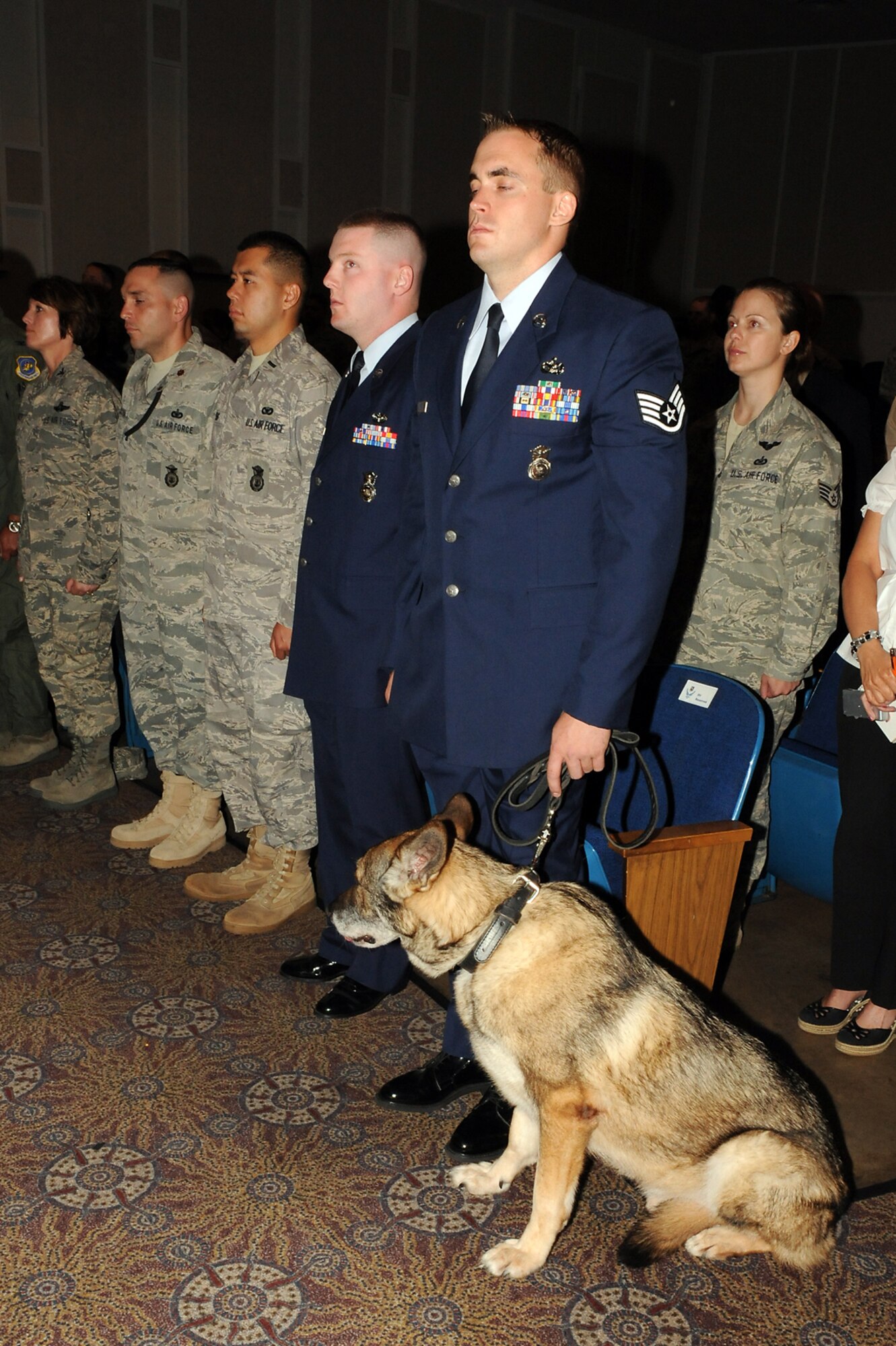 Staff Sgt. Nicholas Pospischil, 21st Security Forces Squadron, and military working dog Wodan, during Wodan’s retirement ceremony June 8 at Peterson AFB. Wodan was a patrol and explosive detector who served 10 years in the U.S. Air Force, providing protection and support for both handlers and the installation. (U.S. Air Force photo/Roberta McDonald)