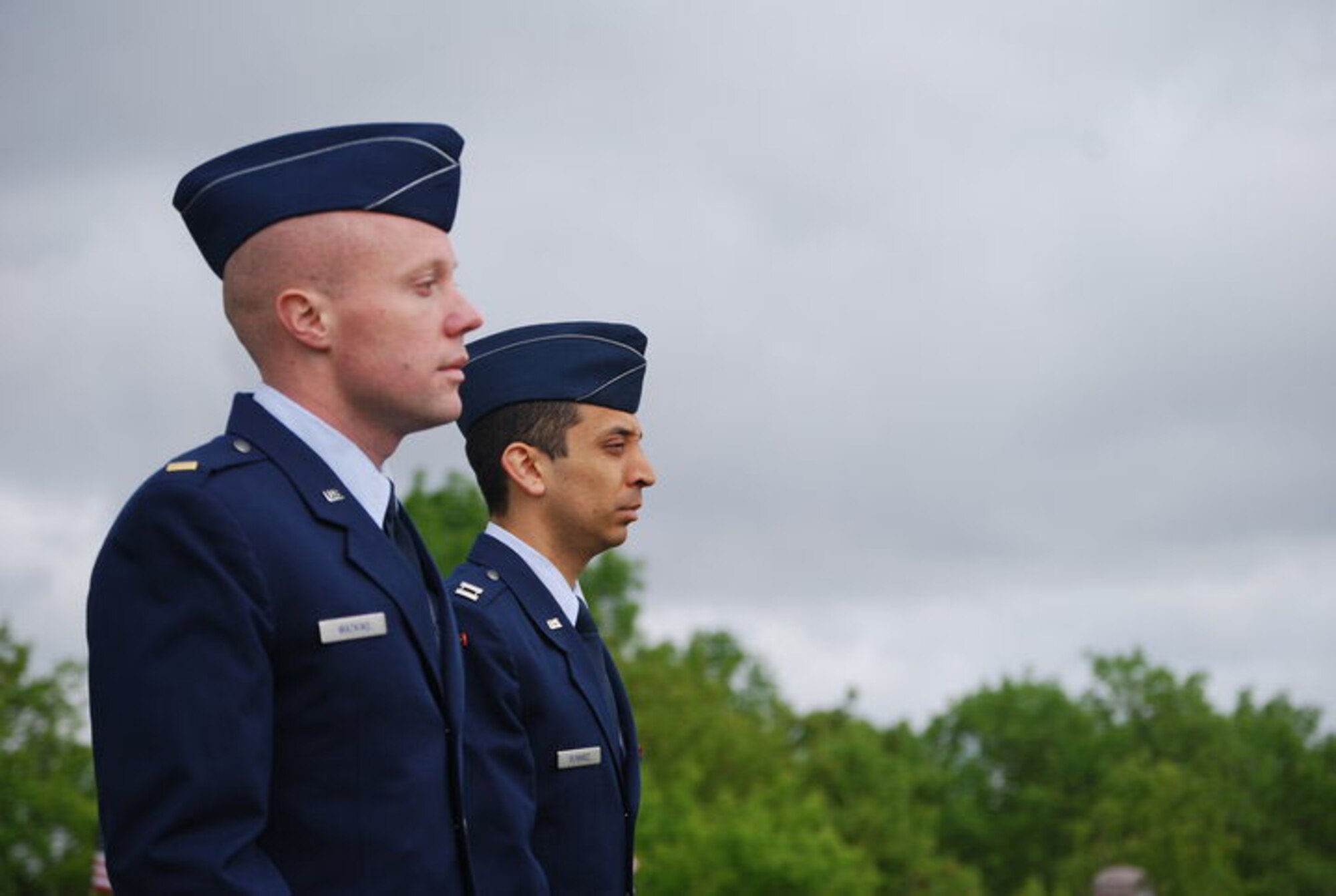 2nd Lt. Deal Watkins (left), 10th SWS crew commander and Capt. Ruben Olivarez, 10th SWS operations flight commander, stand at attention during the playing of taps May 30 in Milton, N.D. Airmen from the 10th SWS participated in a variety of Memorial Day activities around the community. (Courtesy photo/Jo Olivarez)