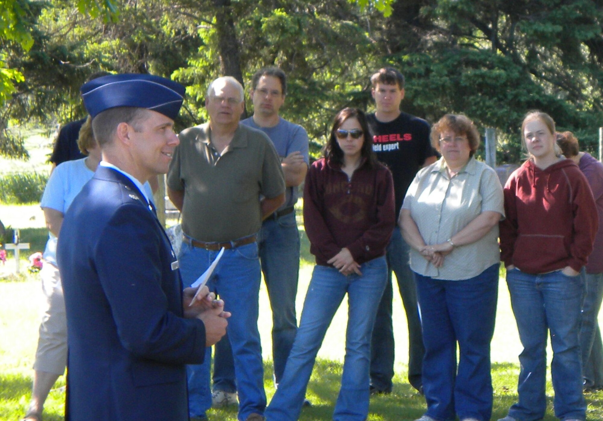 Lt. Col. John Thomas, 10th Space Warning Squadron commander, addresses a crowd in a cemetery near Mountain, N.D., May 31, about the significance and origins of Memorial Day. Airmen from the 10th SWS participated in a variety of Memorial Day activities around the community. (U.S. Air Force photo/2nd Lt. Francisco Vazquez)