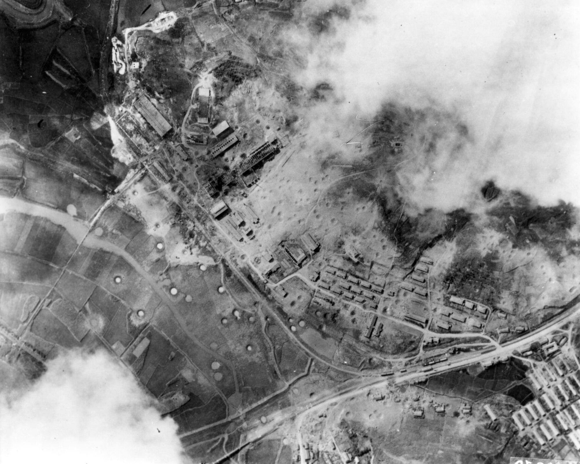 Post-strike photos of a munitions factory at Nakwon near Sinuiju, North Korea, on the Yalu River. On the night of Aug. 18, 1952, B-29s dropped 140 tons of bombs on it using electronic aiming methods. The attack destroyed fifteen buildings, including the main factory, and damaged 17 others. (U.S. Air Force photo)