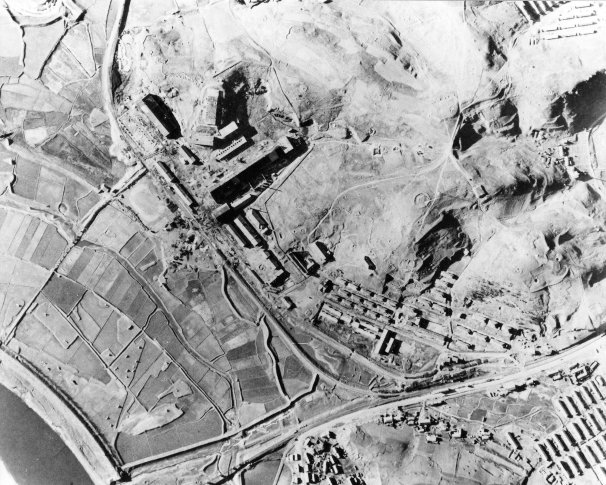 Pre-strike photos of a munitions factory at Nakwon near Sinuiju, North Korea, on the Yalu River. On the night of Aug. 18, 1952, B-29s dropped 140 tons of bombs on it using electronic aiming methods. The attack destroyed fifteen buildings, including the main factory, and damaged 17 others. (U.S. Air Force photo)