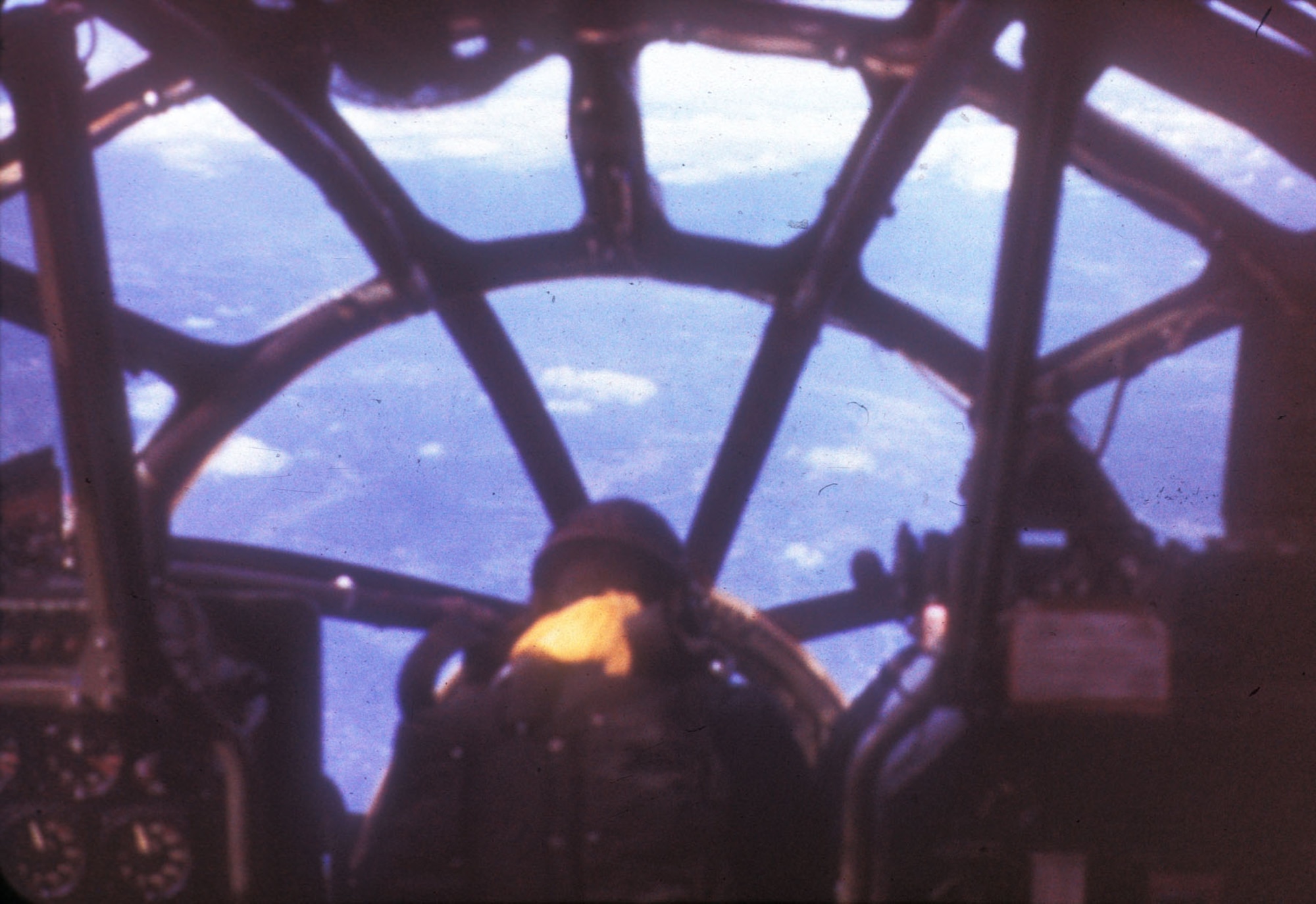 B-29 bombardier hunched over the bombsight in the nose. (U.S. Air Force photo)