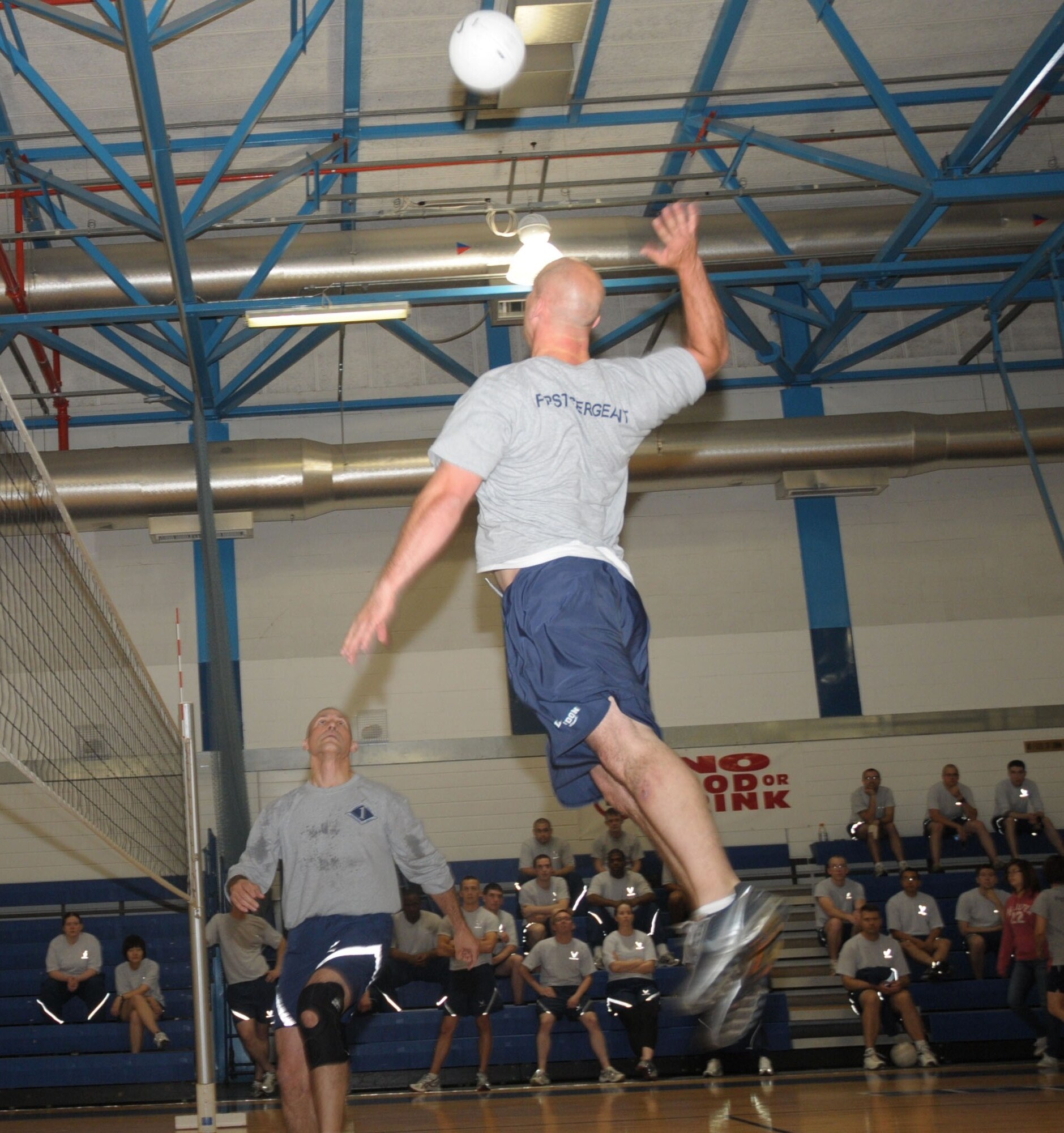 Master Sgt. Patrick Piazza, 48th Communications Squadron first sergeant, soars high to spike the ball after a pass by teammate Master Sgt. Rafael Chacon, 48th Operations Group first sergeant, during the Airman Leadership School versus first sergeants volleyball game at the RAF Lakenheath Fitness Center June 11. The first sergeants came away victorious winning all four games. (U.S. Air Force photo/Staff Sgt. Connor Estes)