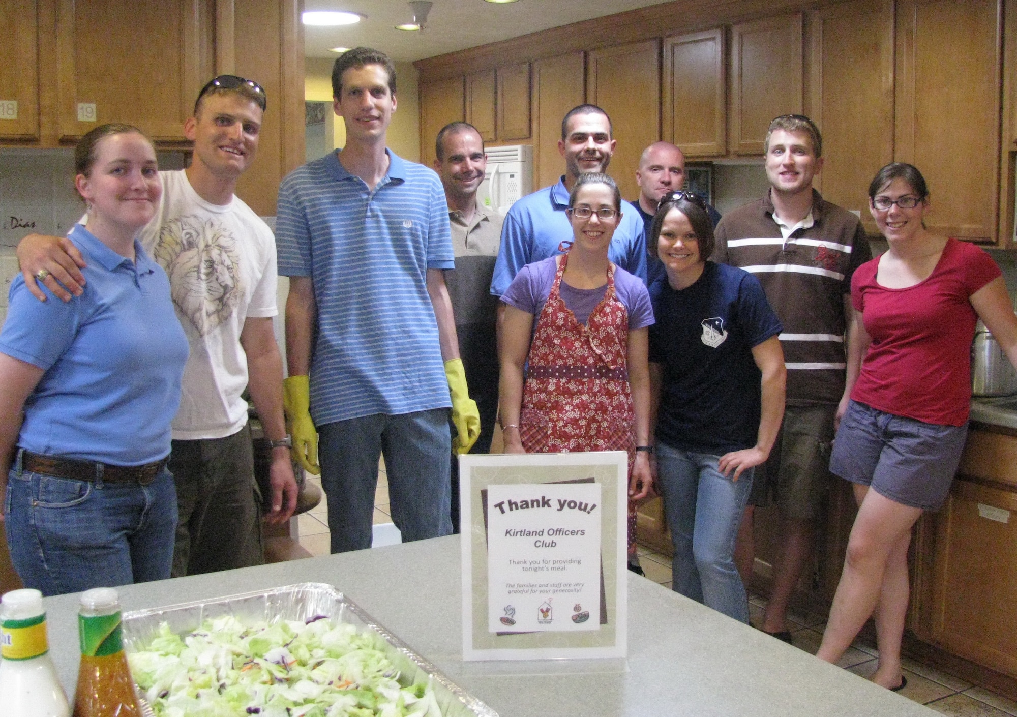 Kirtland AFB Company Grade Officer Council members, family and friends were guest chefs at the Albuquerque Ronald McDonald House. They prepared food for 65 residents. Members are from left, Sarah Elsbernd, 1st Lt. Paul Elsbernd, 709th Nuclear Systems Squadron; Nathan Alexander, Capt. Andy Bigley, Air Force Operational Test and Evaluation Center; 1st Lt. Ryan Davis, 377th Mission Support Group; 1st Lt. Alicia Kaskela, Air Force Safety Center; Capt. Brian Musolino 709th NSS; Capt. Kristen Newsome, 377th Medical Group; 2nd Lt. Reed Elsbernd, Laughlin AFB, Texas; and 2nd Lt. Kelly Cole, Air Force Research Laboratory.  Courtesy photo