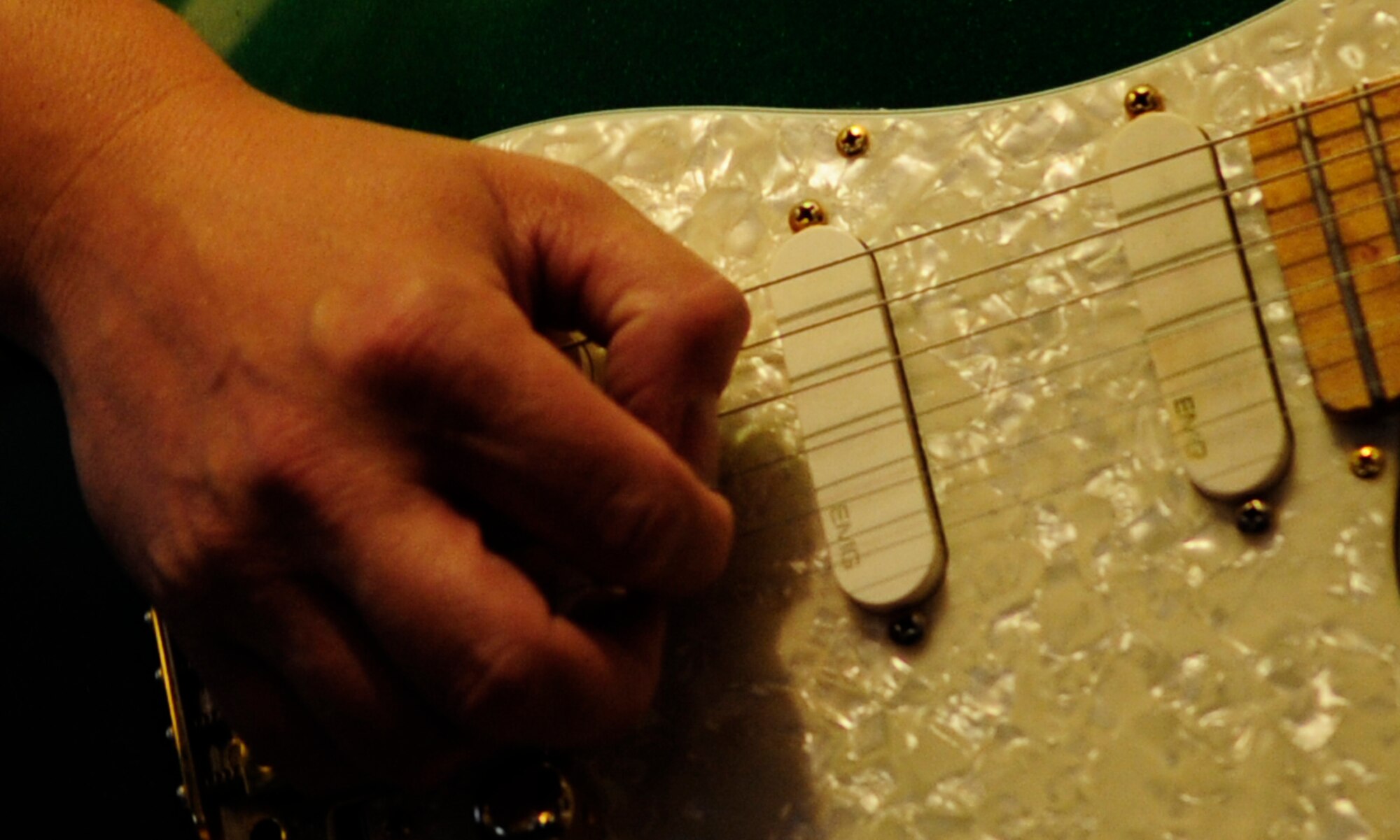 RAF MILDENHALL, England – The strings of a hand-made Manson guitar are skillfully played by Dave Golding, 100th Logistics and Readiness Squadron, during a performance at the Rose and Crown pub in Beck Row June 11.  (U.S. Air Force photo/Staff Sgt. Christopher L. Ingersoll)