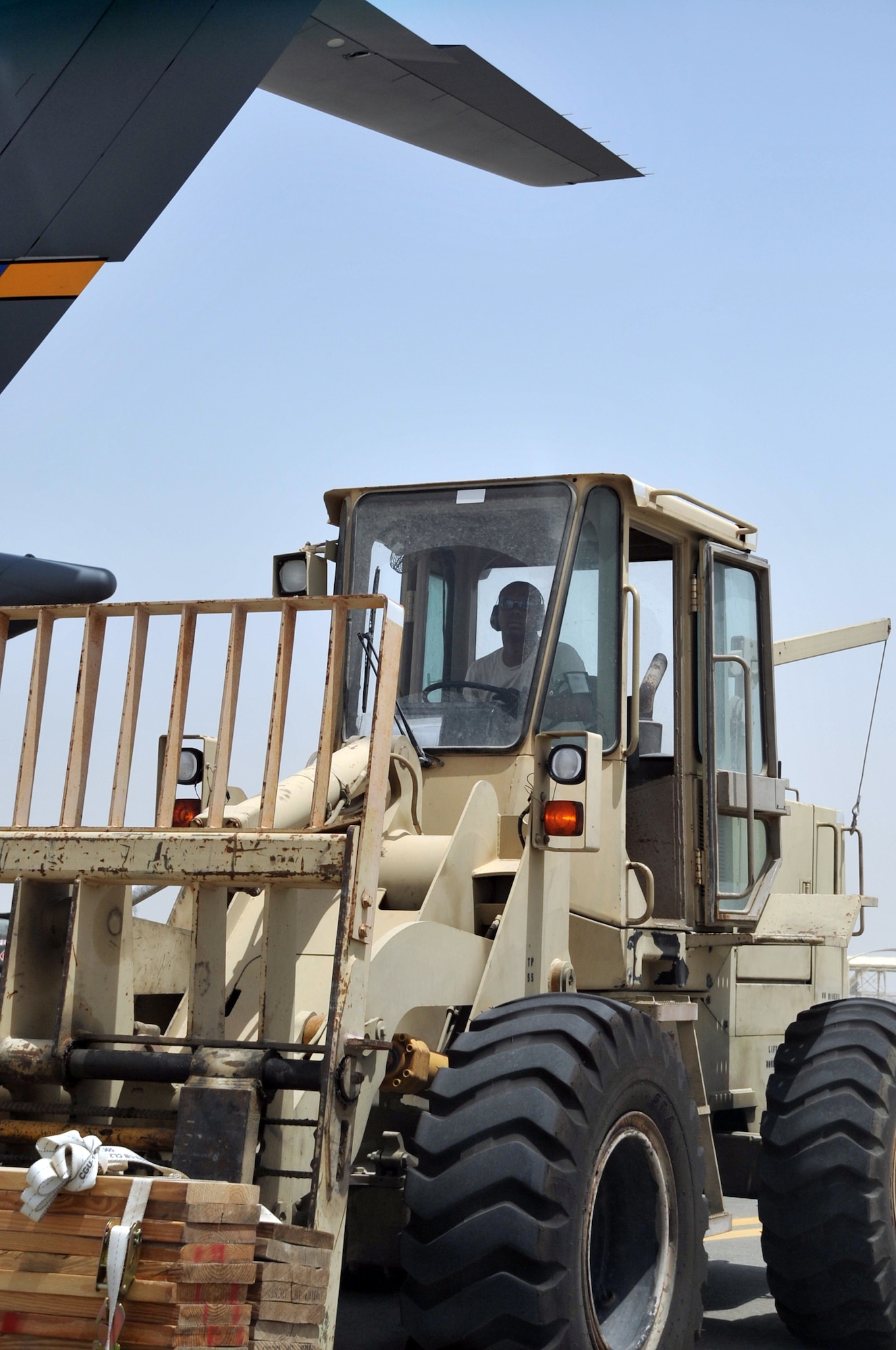 Senior Airman Nicholas Worrell, air transportation journeyman with the 380th Expeditionary Logistics Readiness Squadron Air Terminal Operations Center, drives an extreme terrain forklift in the ATOC yard during operations for the 380th Air Expeditionary Wing at a non-disclosed base in Southwest Asia on May 19, 2010. Airman Worrell is deployed from the 89th Aerial Port Squadron at Joint Base Andrews, Md., and his hometown is Robins, Iowa. (U.S. Air Force Photo/Master Sgt. Scott T. Sturkol/Released)