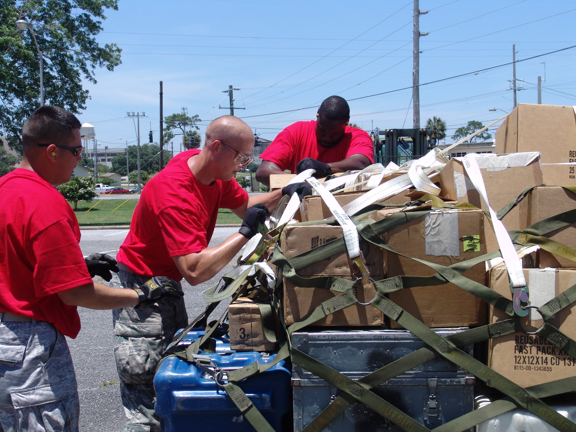 Members of the red team tie down cargo after building a pallet during the 96th Logistics Readiness Squadron's ROADEO June 11.  (USAF photo/Lois Walsh)