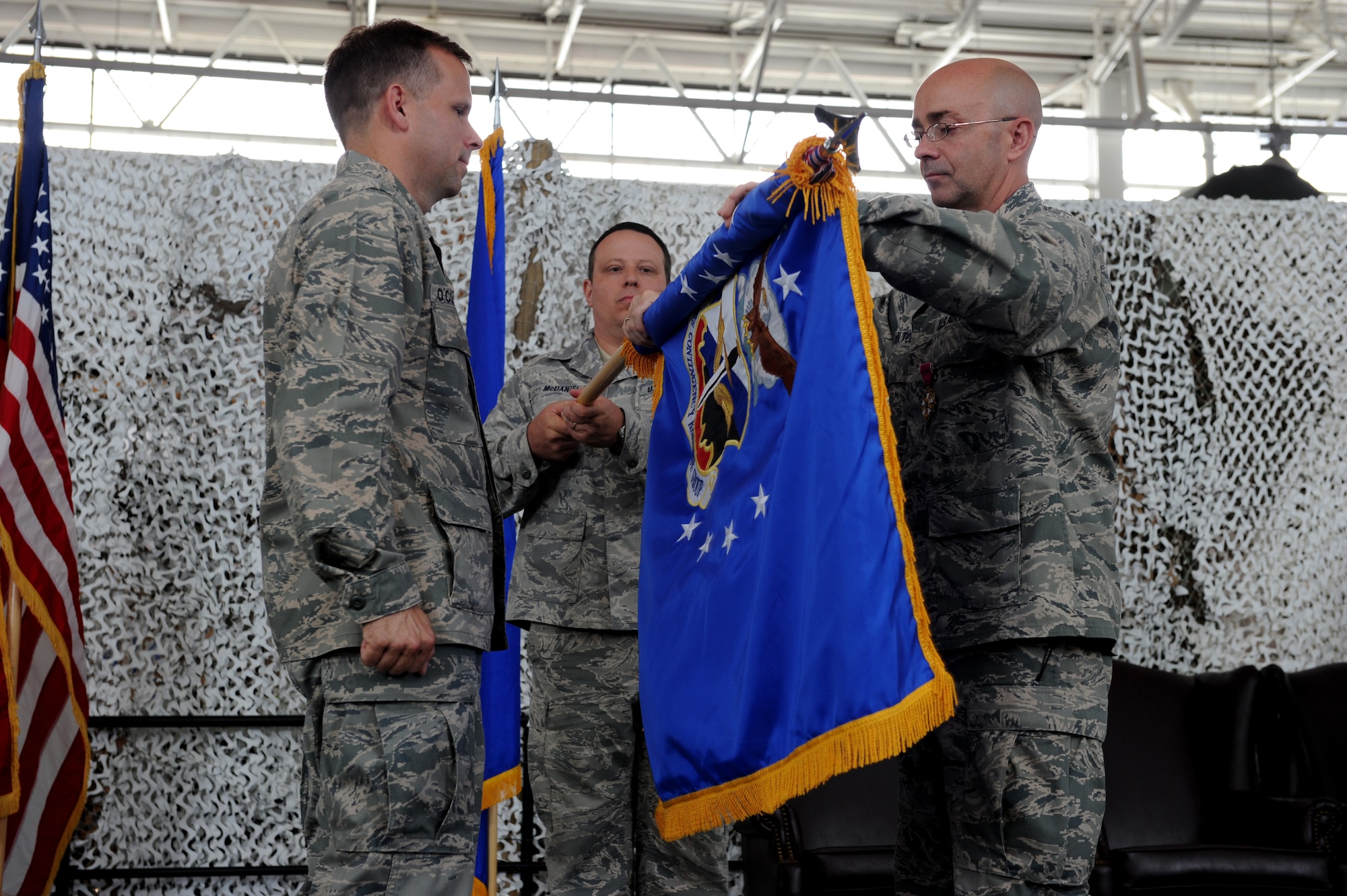 JOINT BASE MCGUIRE-DIX-LAKEHURST, N.J. -- Col. James Hamilton, 816th Contingency Response Group commander, cases his squadrons colors during its inactivation ceremony here June 11. The inactivation will boost the capabilities of the wing’s two remaining Contingency Response Groups and assist with the creation of an Air National Guard CRG. (U.S. Air Force photo/Tech. Sgt. Laura Deckman/released) 