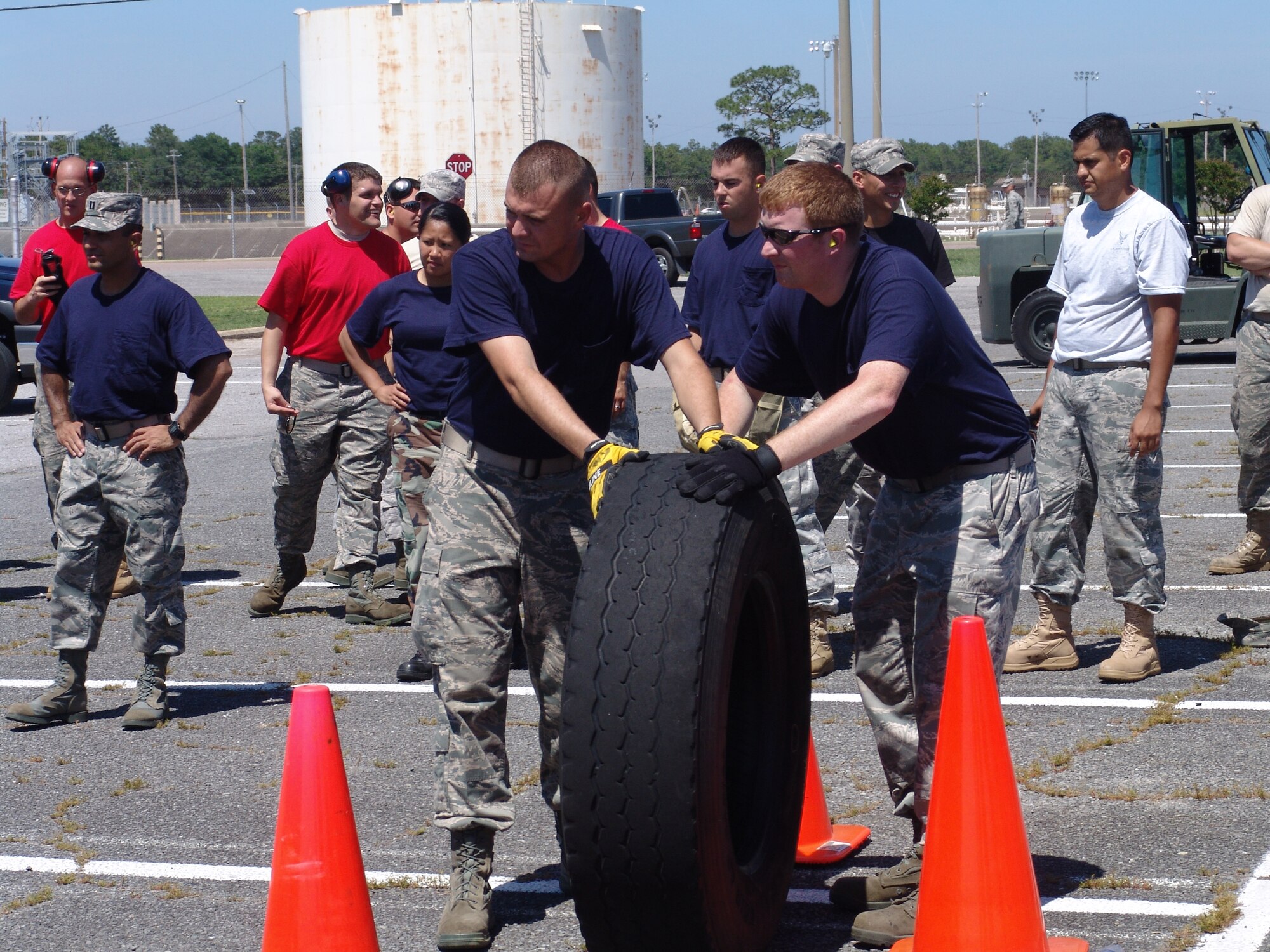 Members of the Blue Team get ready to roll a tire through an obstacle course as part of the 96th Logistic Readiness Squadron's ROADEO June 11. (USAF photo/Lois Walsh)